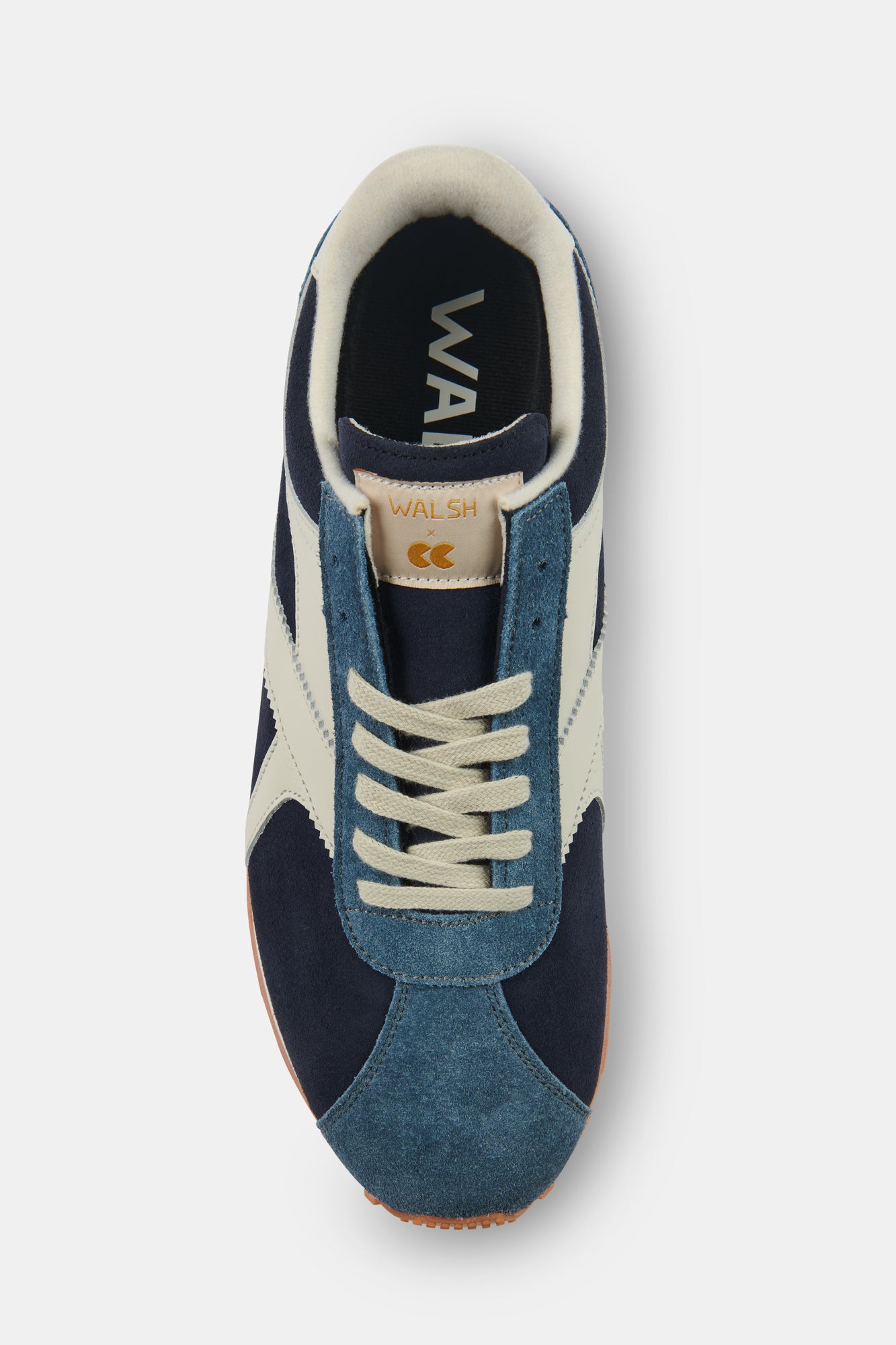 Navy and white trainer with branding on a white background.