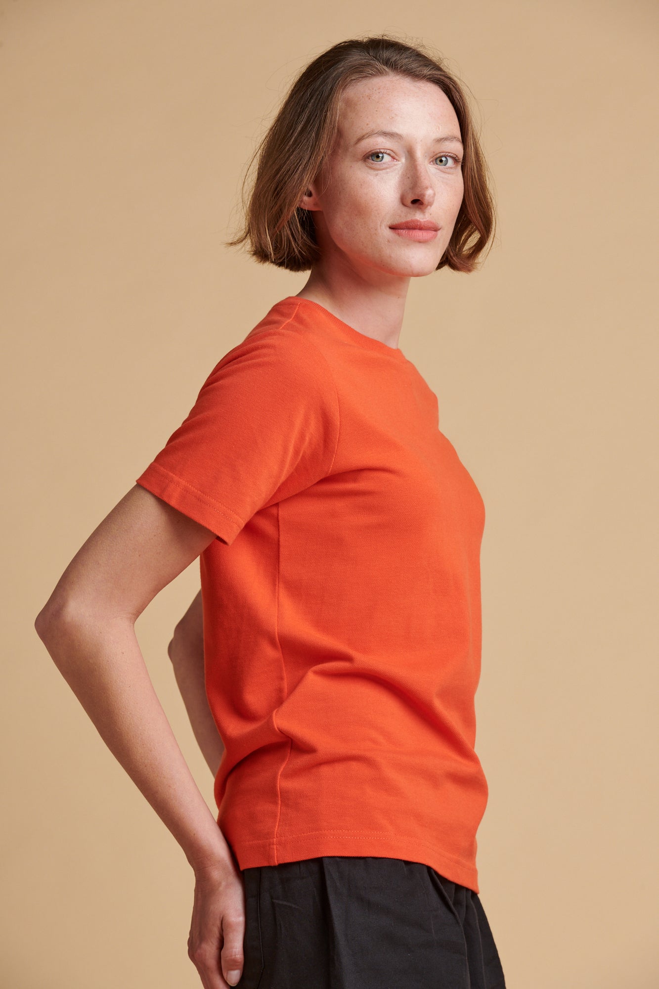 Female wearing breathable t shirt in flame red.