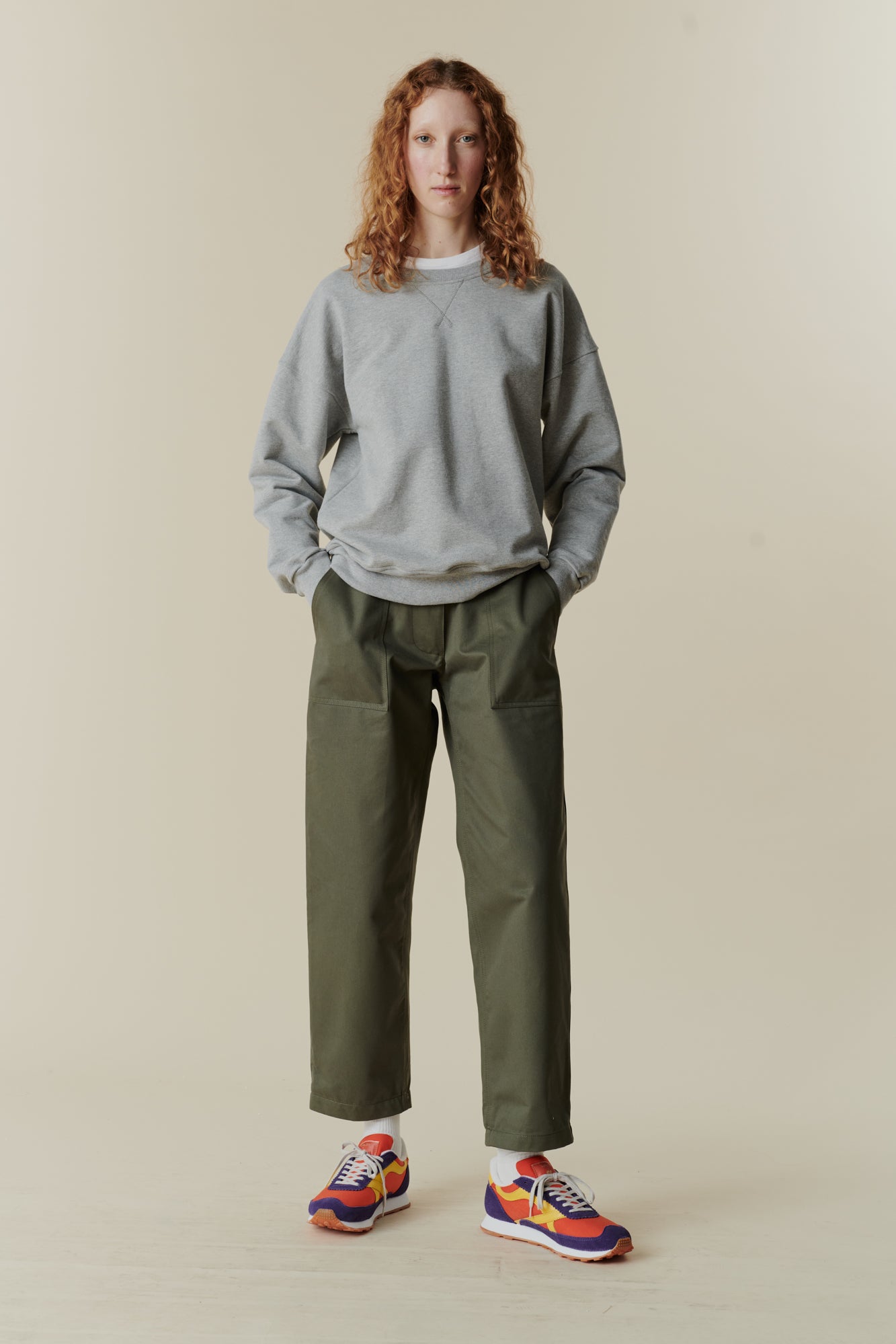 Full body front of female wearing heritage sweatshirt in navy