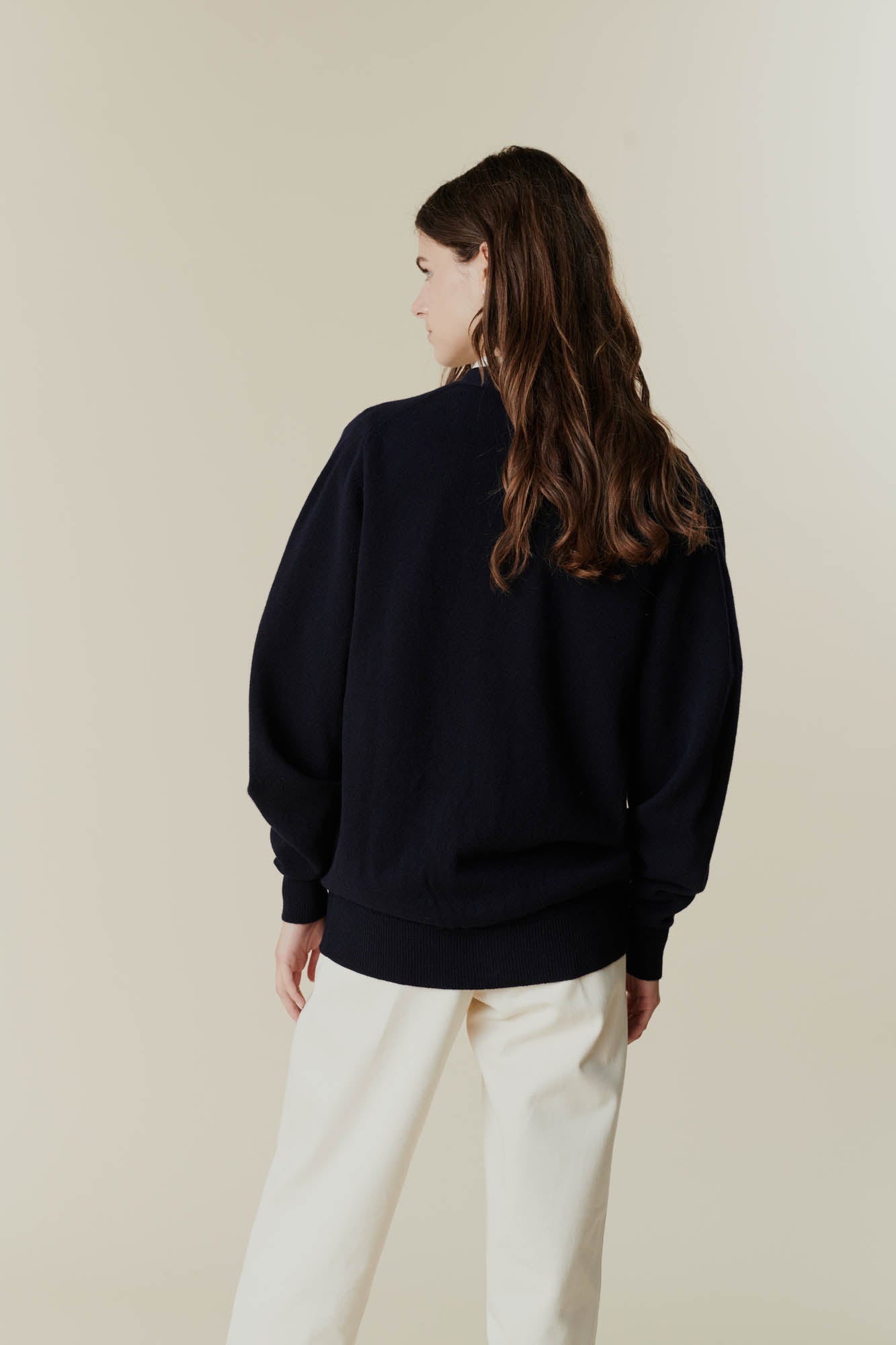 Brunette female wearing lambswool v neck cardigan