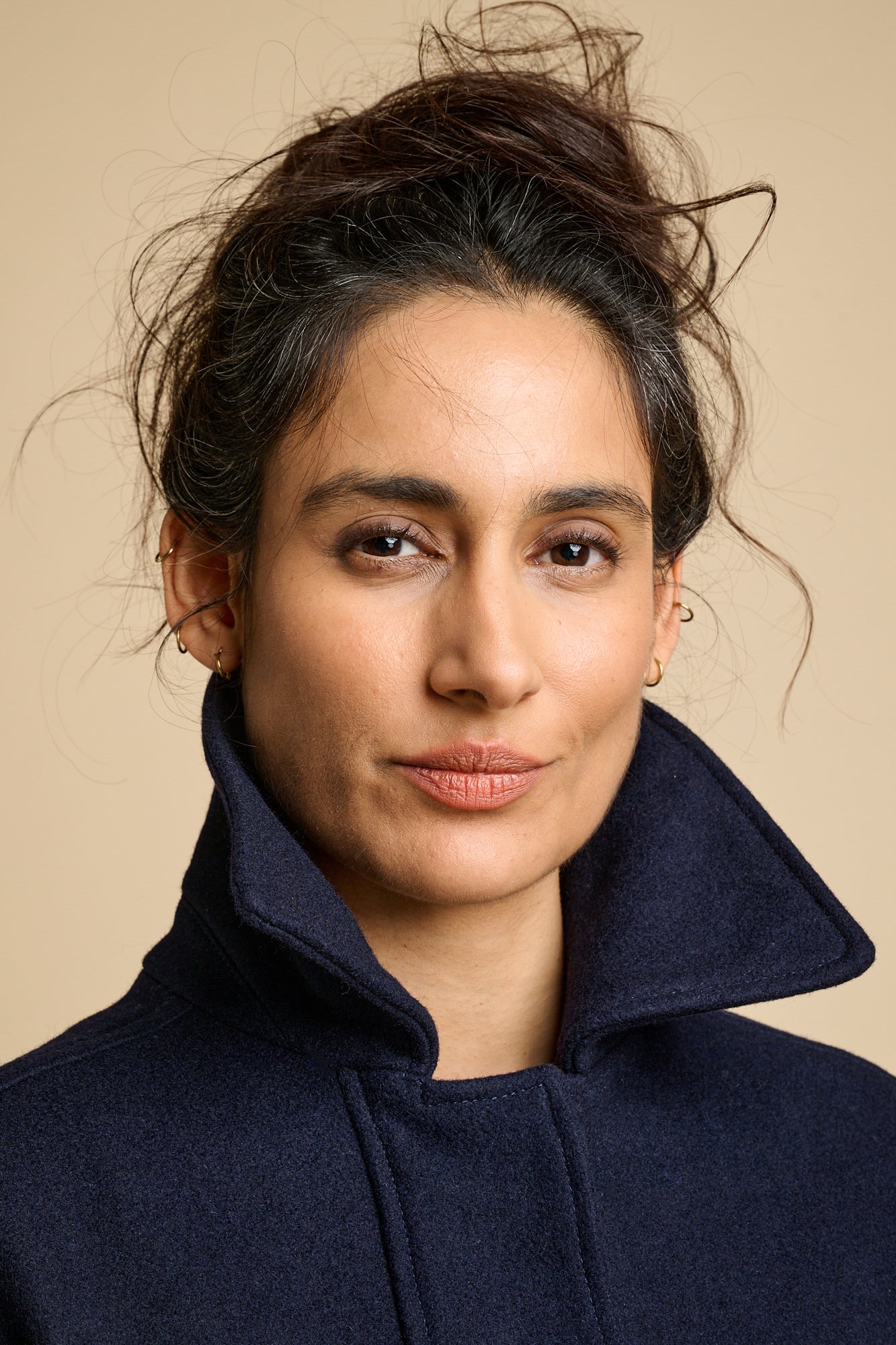 Portrait of woman wearing Nancy short wool coat with the collar up.