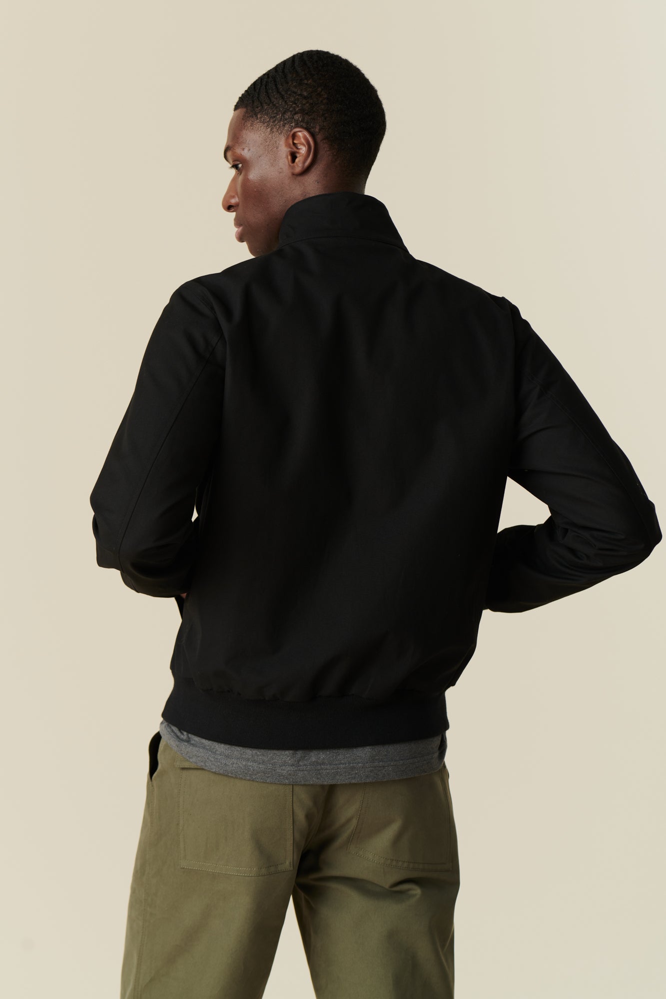 ack of male wearing black Harrington jacket