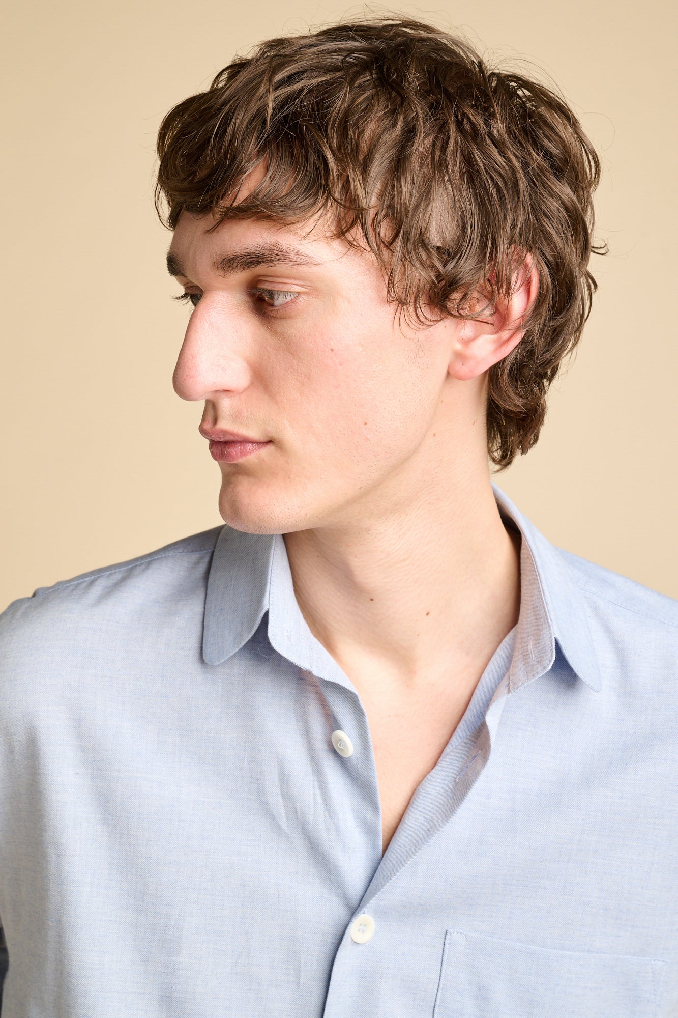 Portrait of a man wearing light blue shirt.