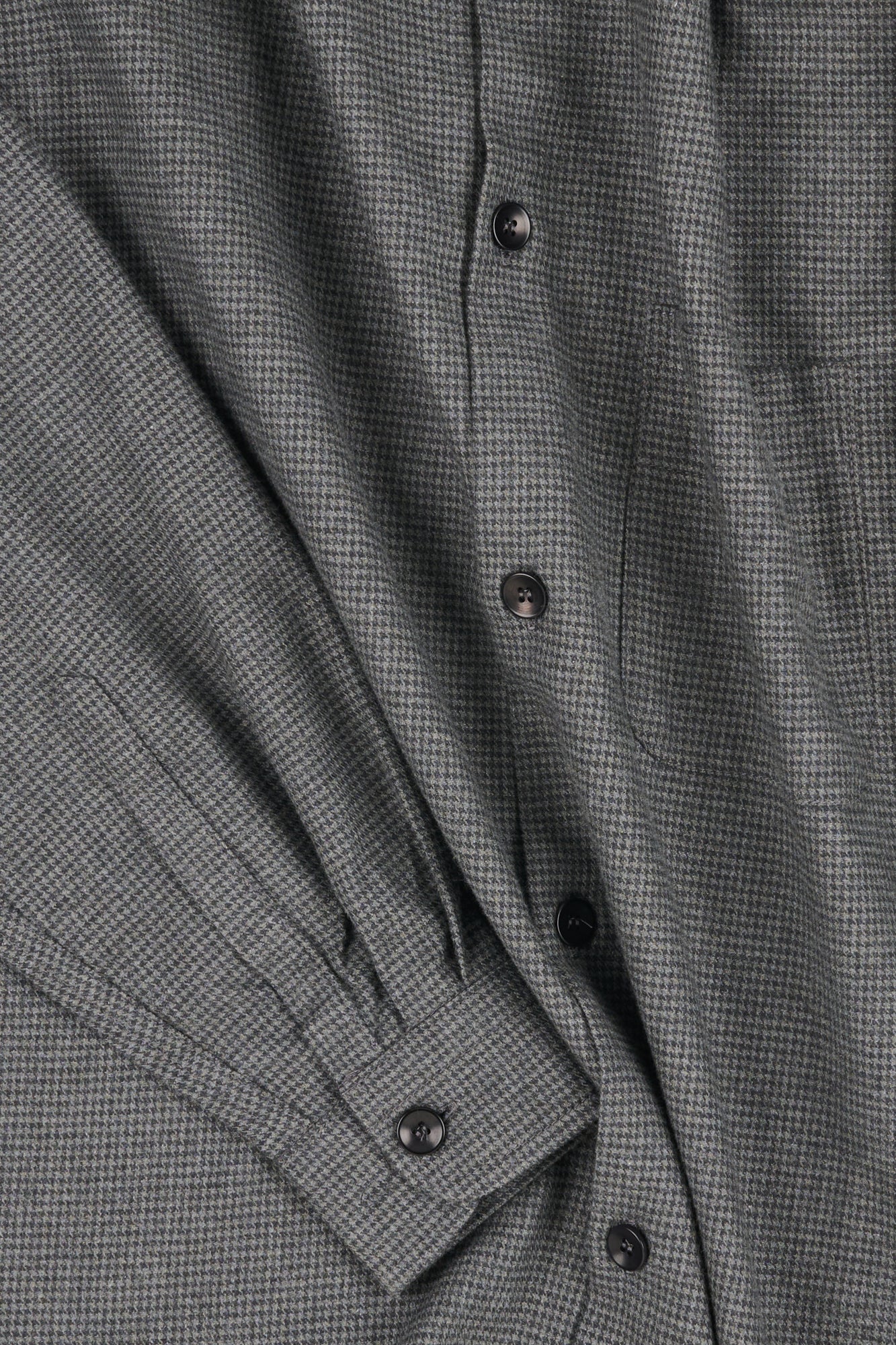 Close-up of a grey puppytooth shirt fabric