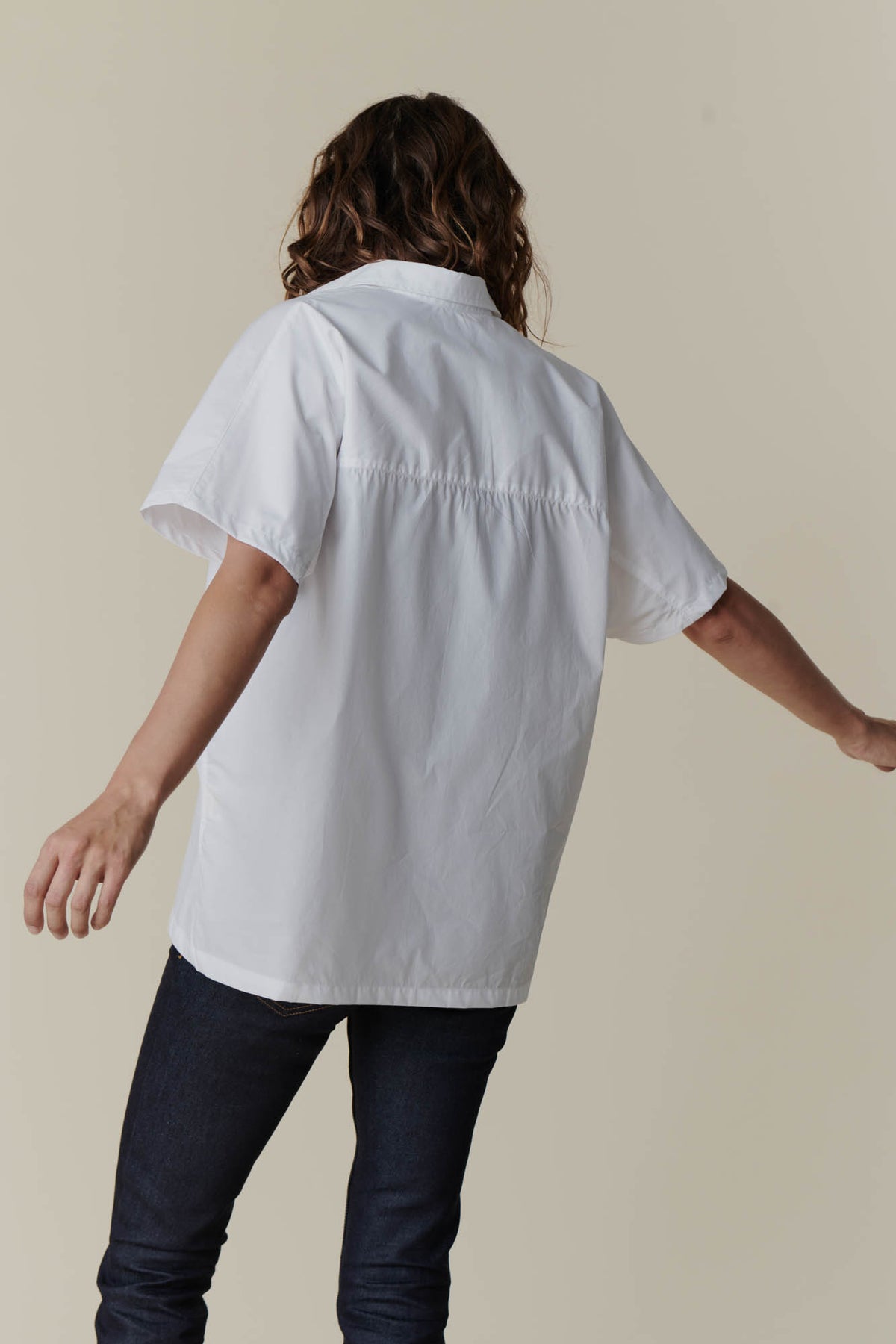 The back of female wearing Ava short sleeve shirt in white