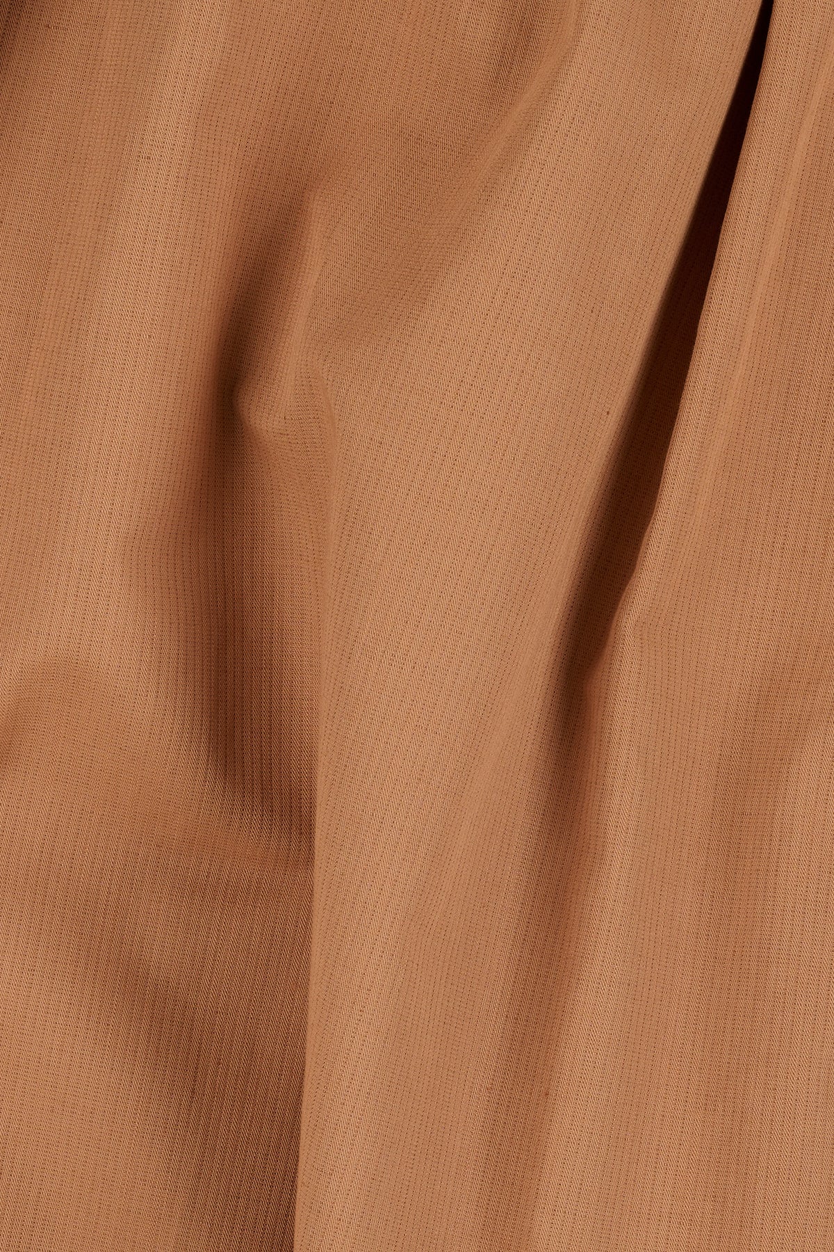 Close-up of cinnamon fabric texture.