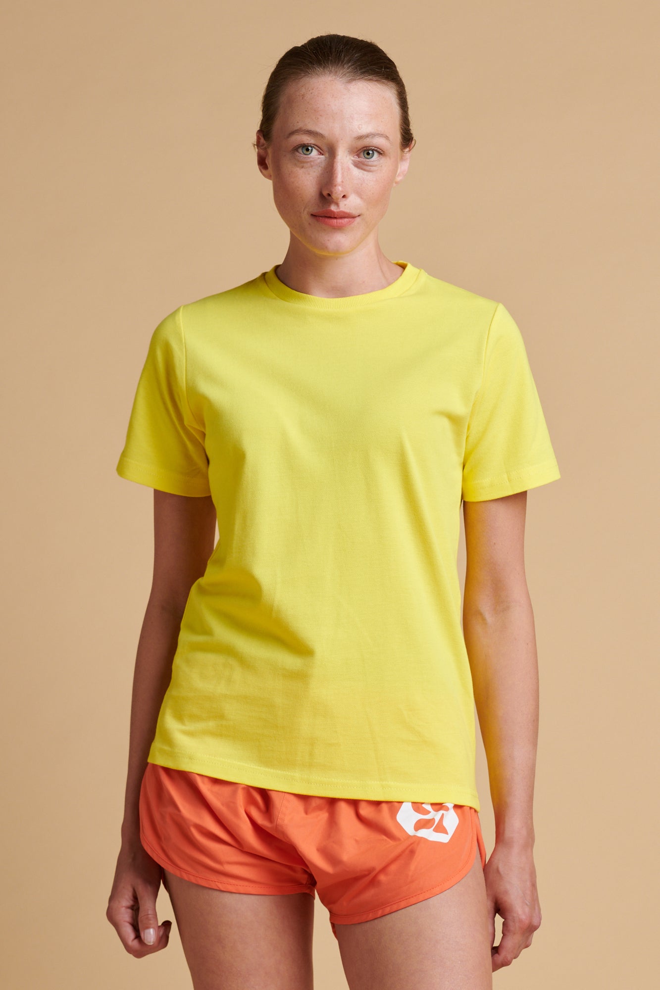 Female wearing breathable t shirt in canary yellow.