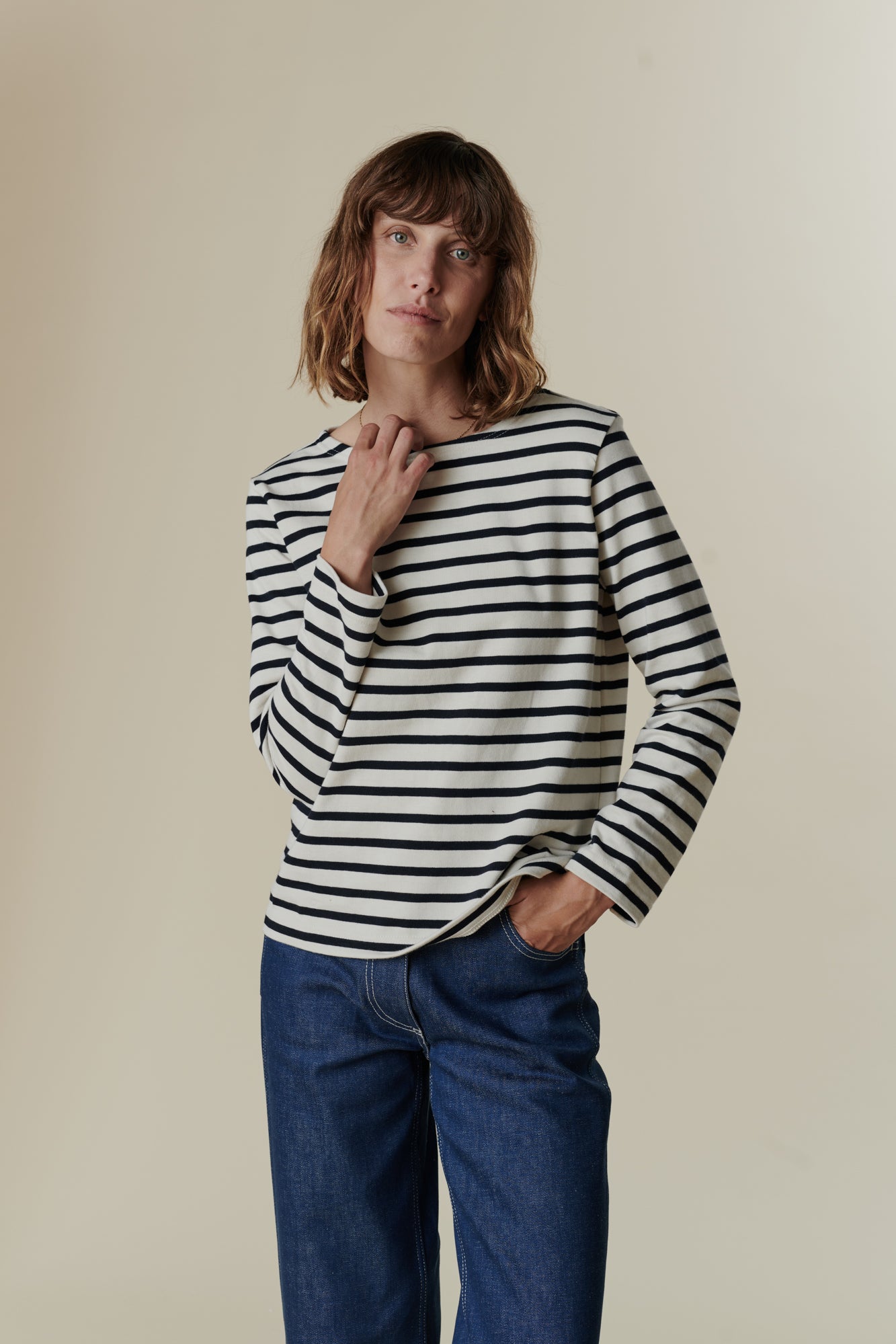 Full body image of female wearing breton in ecru navy stripe