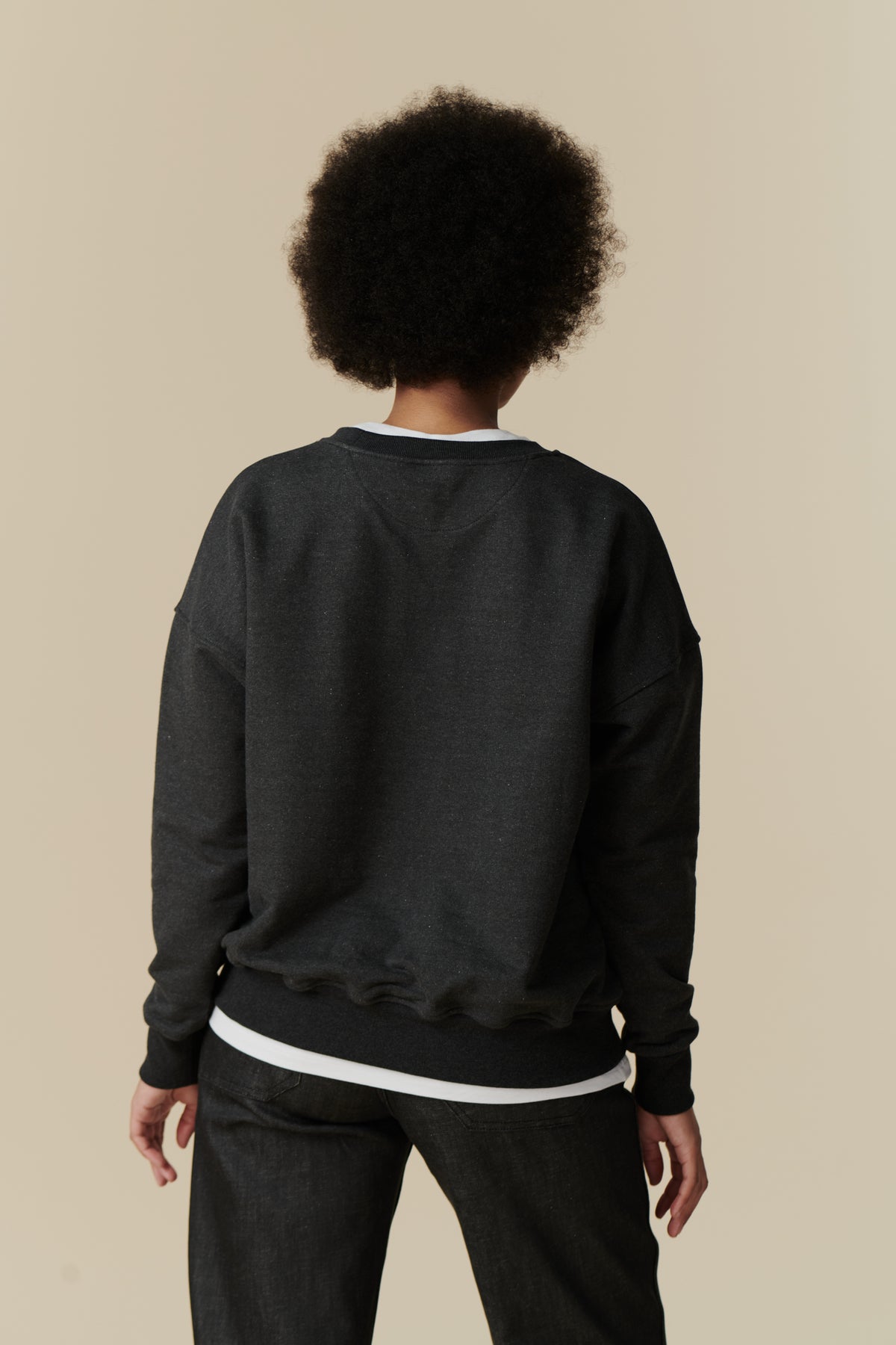 Female wearing heritage sweatshirt in charcoal thigh up back