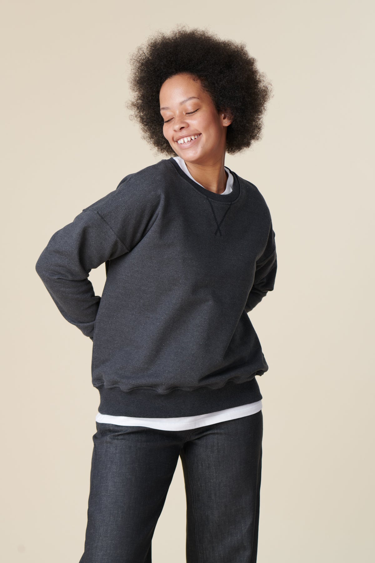 Female wearing heritage sweatshirt in charcoal thigh up front