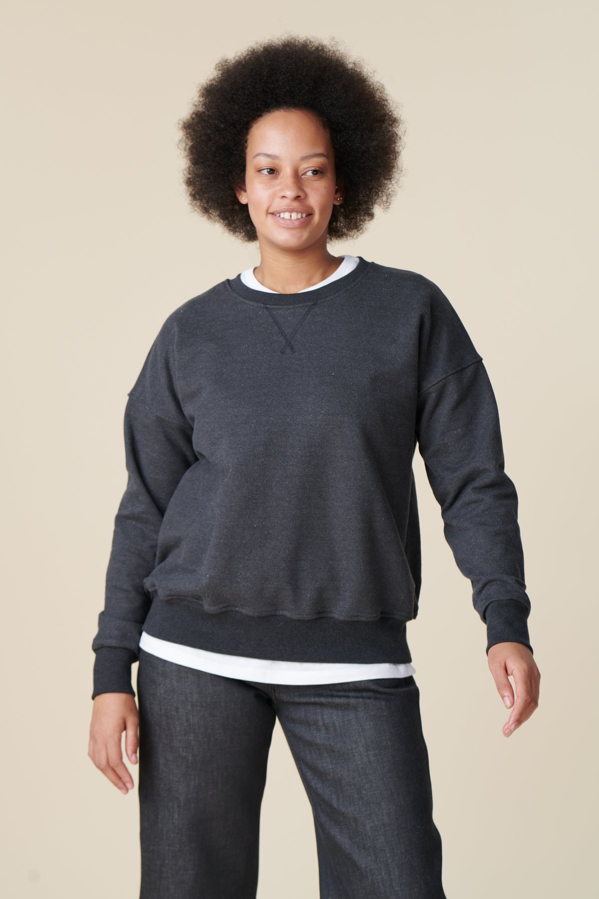 Female wearing heritage sweatshirt in charcoal thigh up front