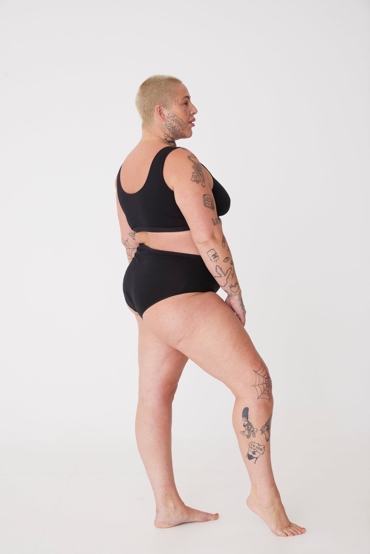 tattooed, plus size, white female in black high rise brief 