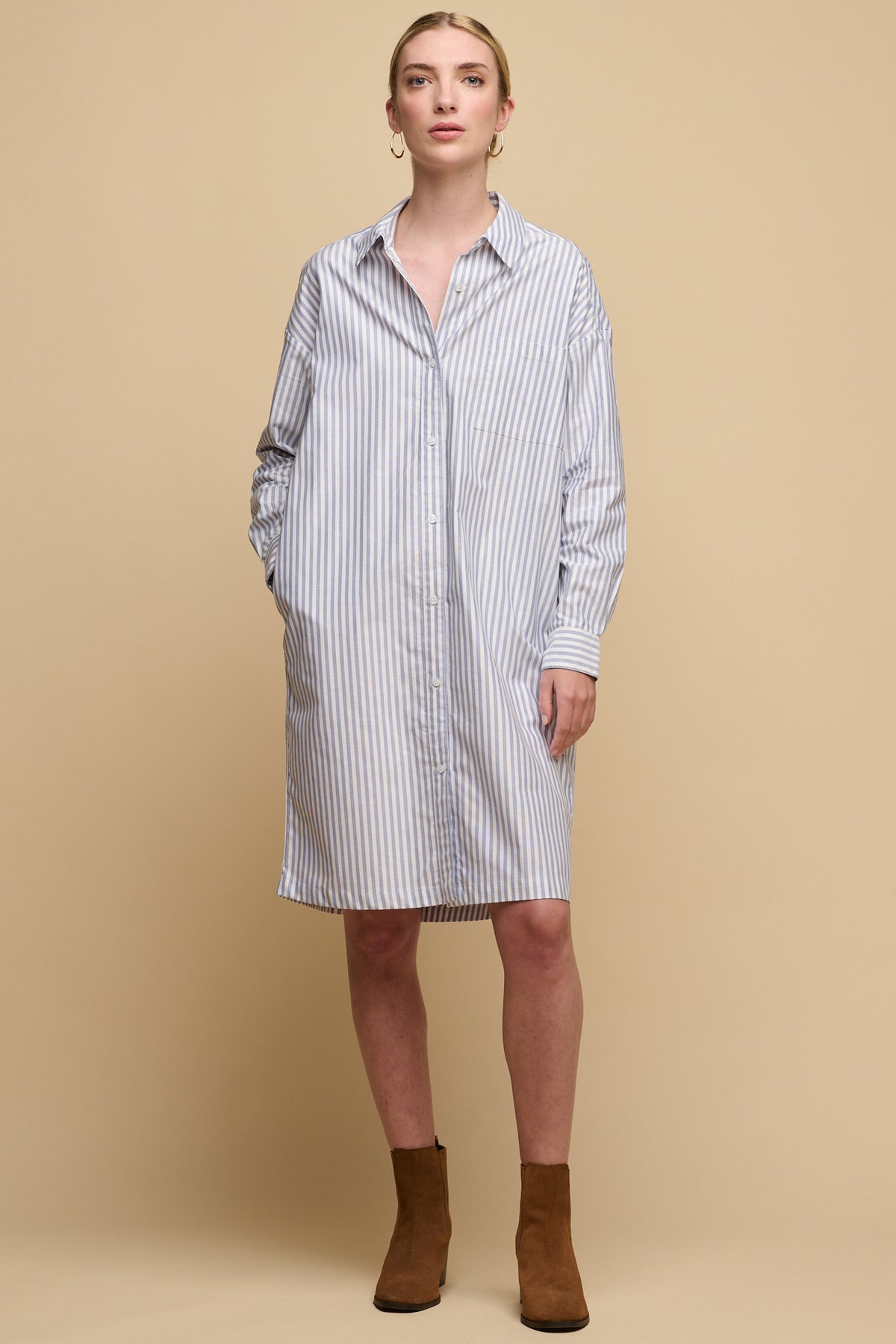white female wearing Lorelle dress unbelted for a loose, relaxed fit with hand in pocket