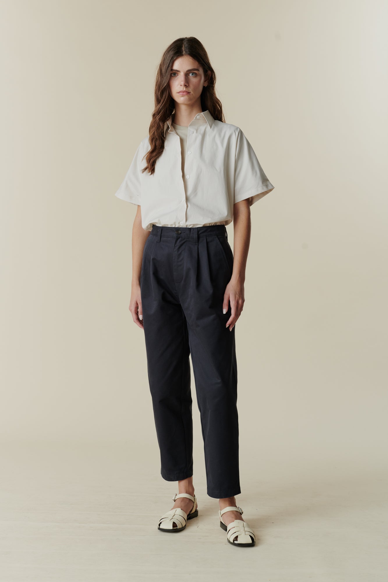 Female wearing pleated jeans in navy 