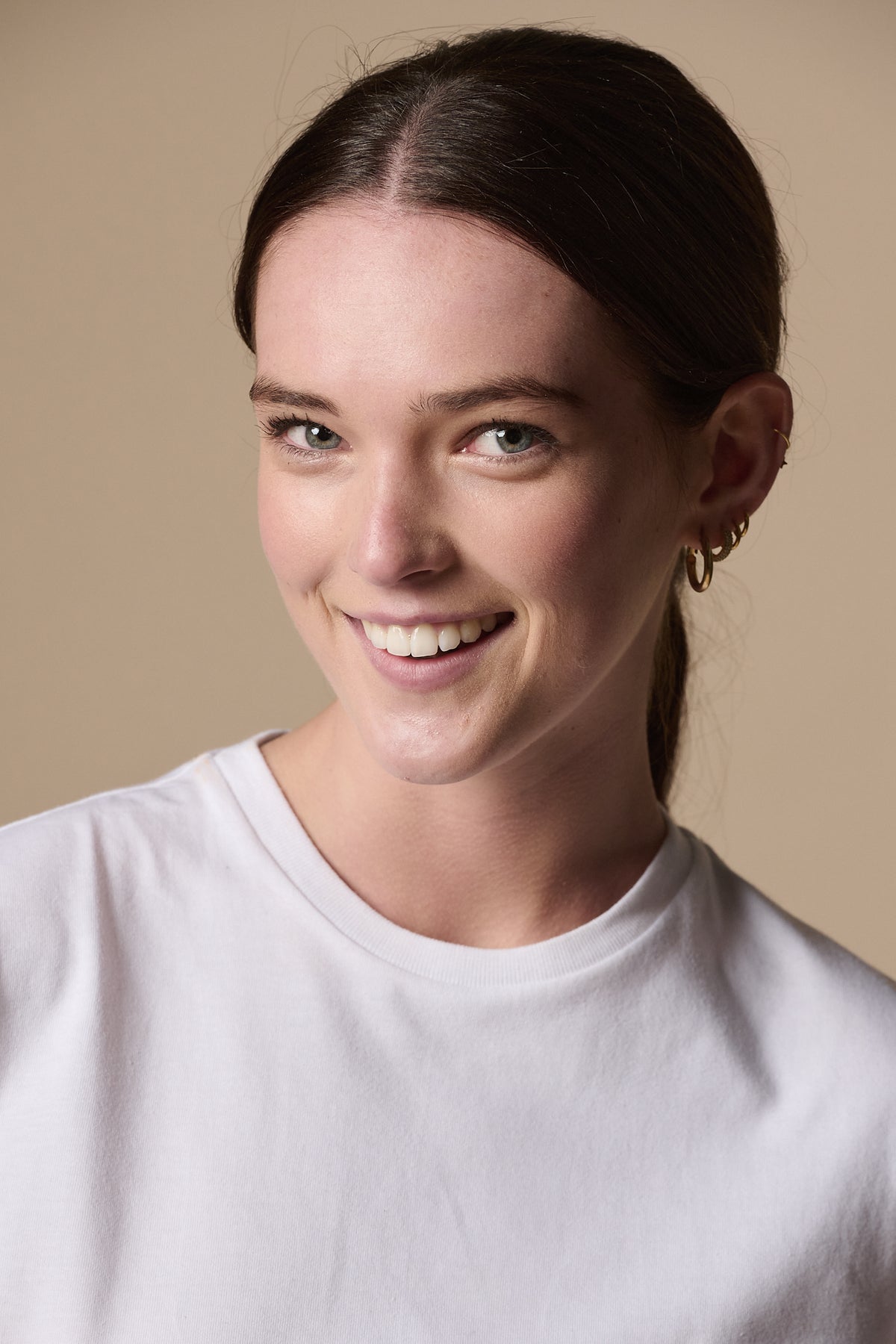 Portrait of smiley female wearing short sleeve t shirt plastic free in white