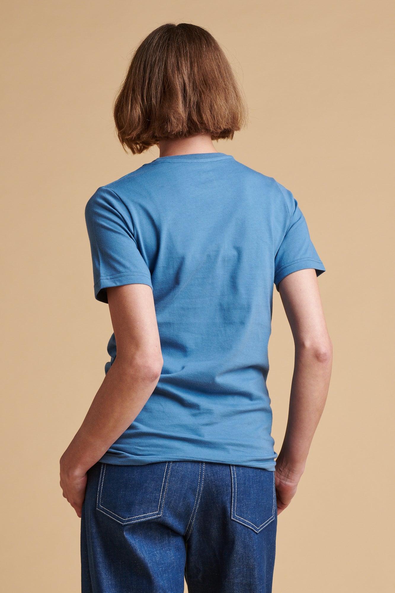 The back of female wearing short sleeve t shirt in RAF blue.