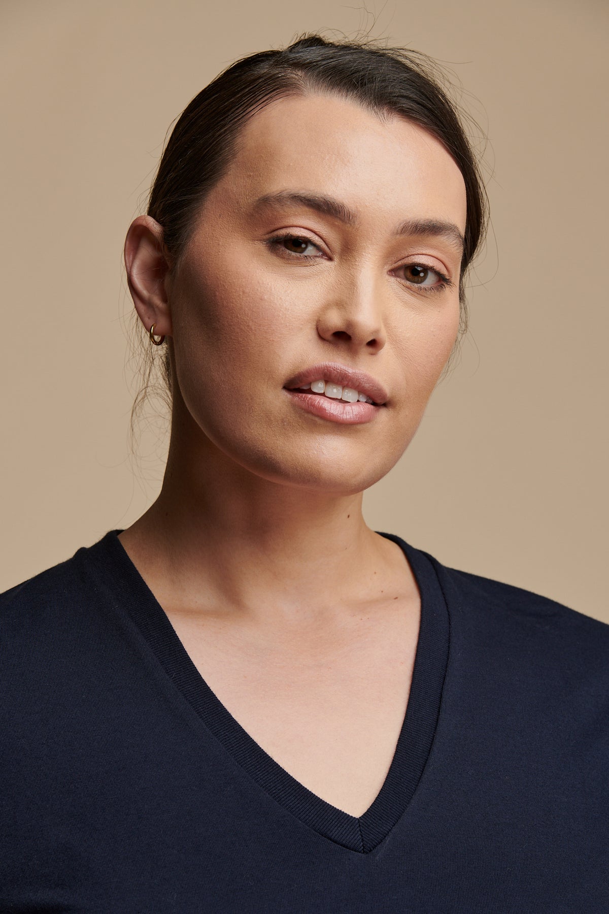 Portrait of female with hair wearing short sleeve v neck t shirt in navy 