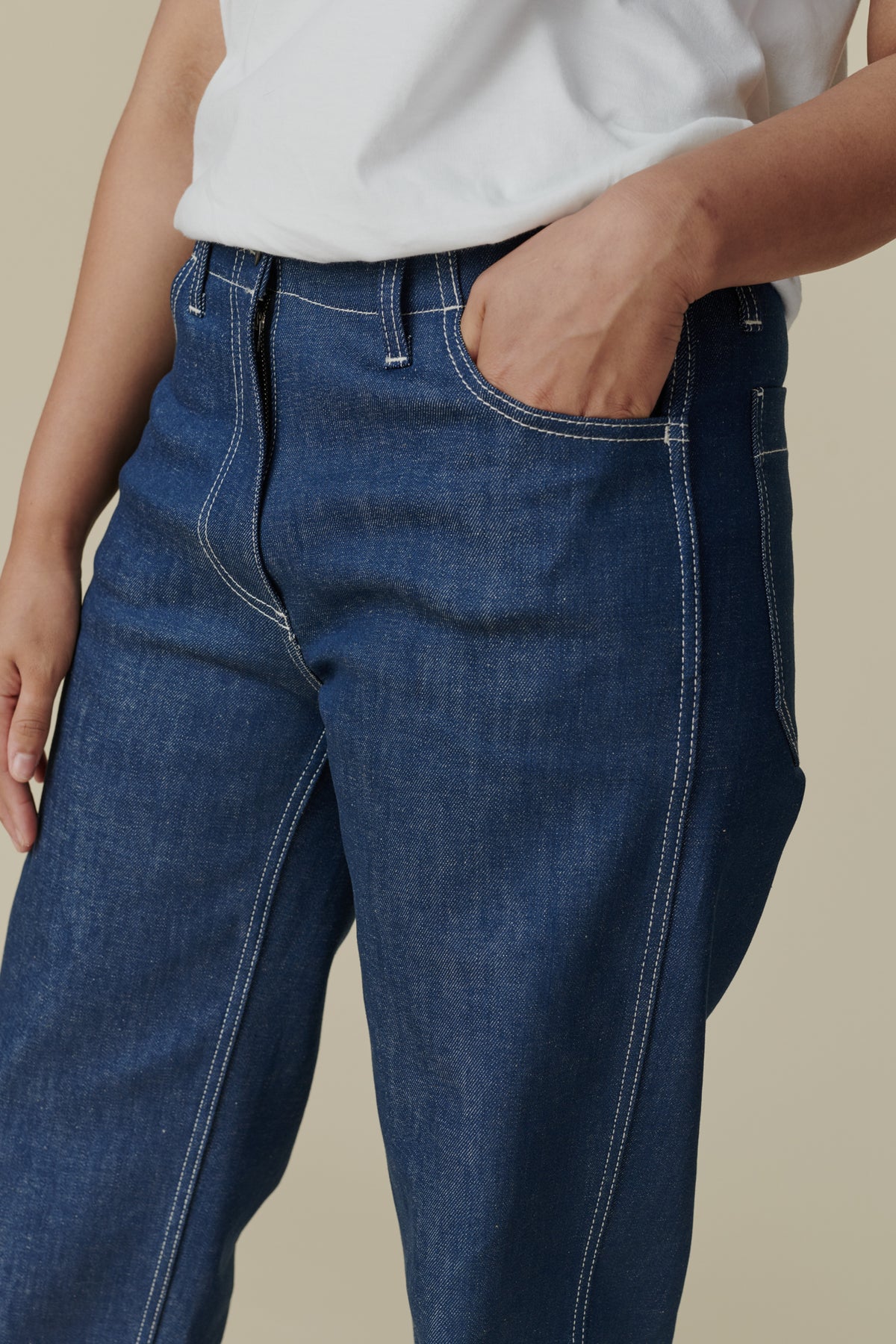 Female wearing white crew neck white t shirt paired with women's work jean in Blue, white contrast stitching, belt loops and front pocket detail