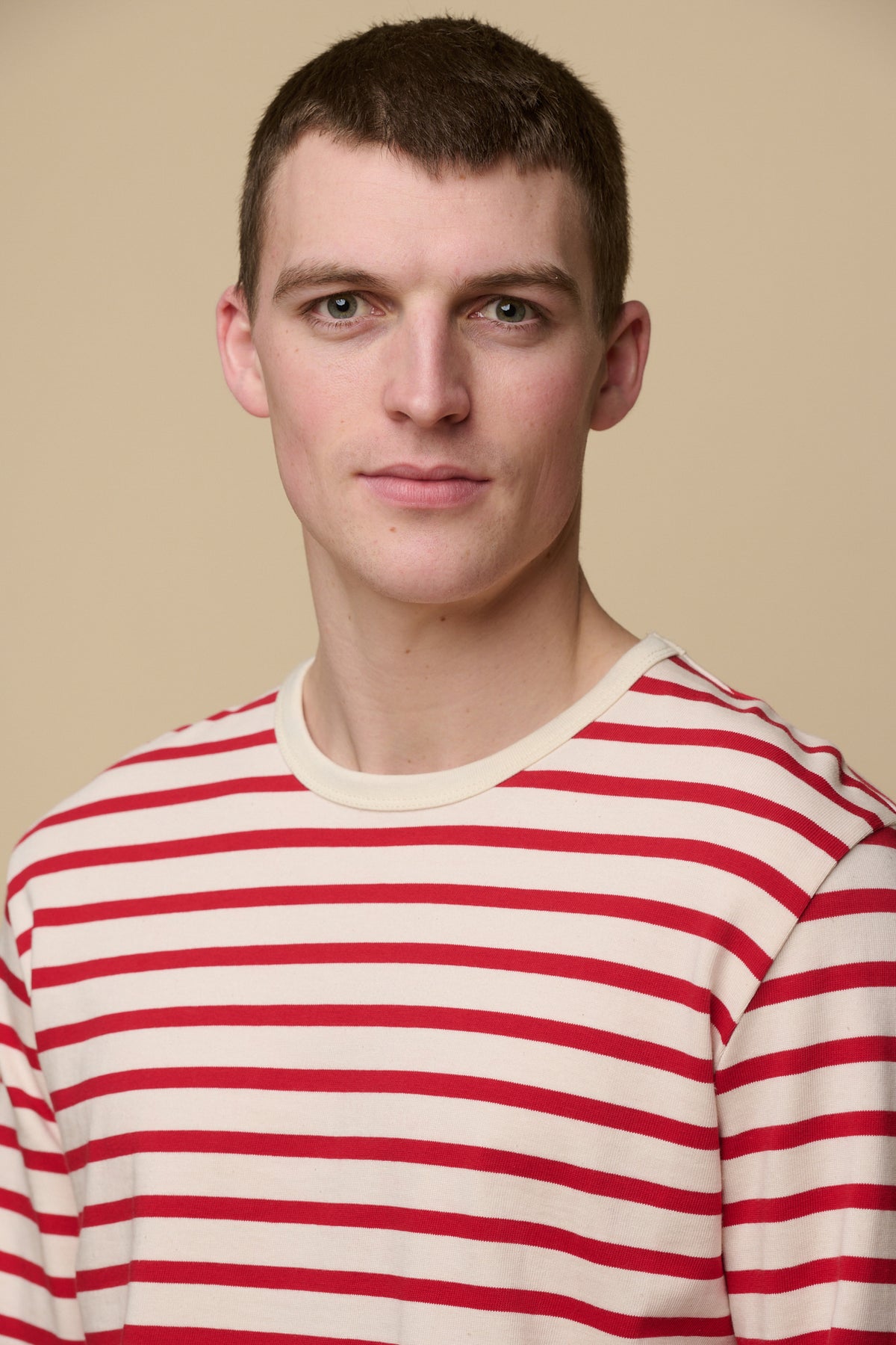 Close up portrait of male wearing Breton in ecru/flame red 