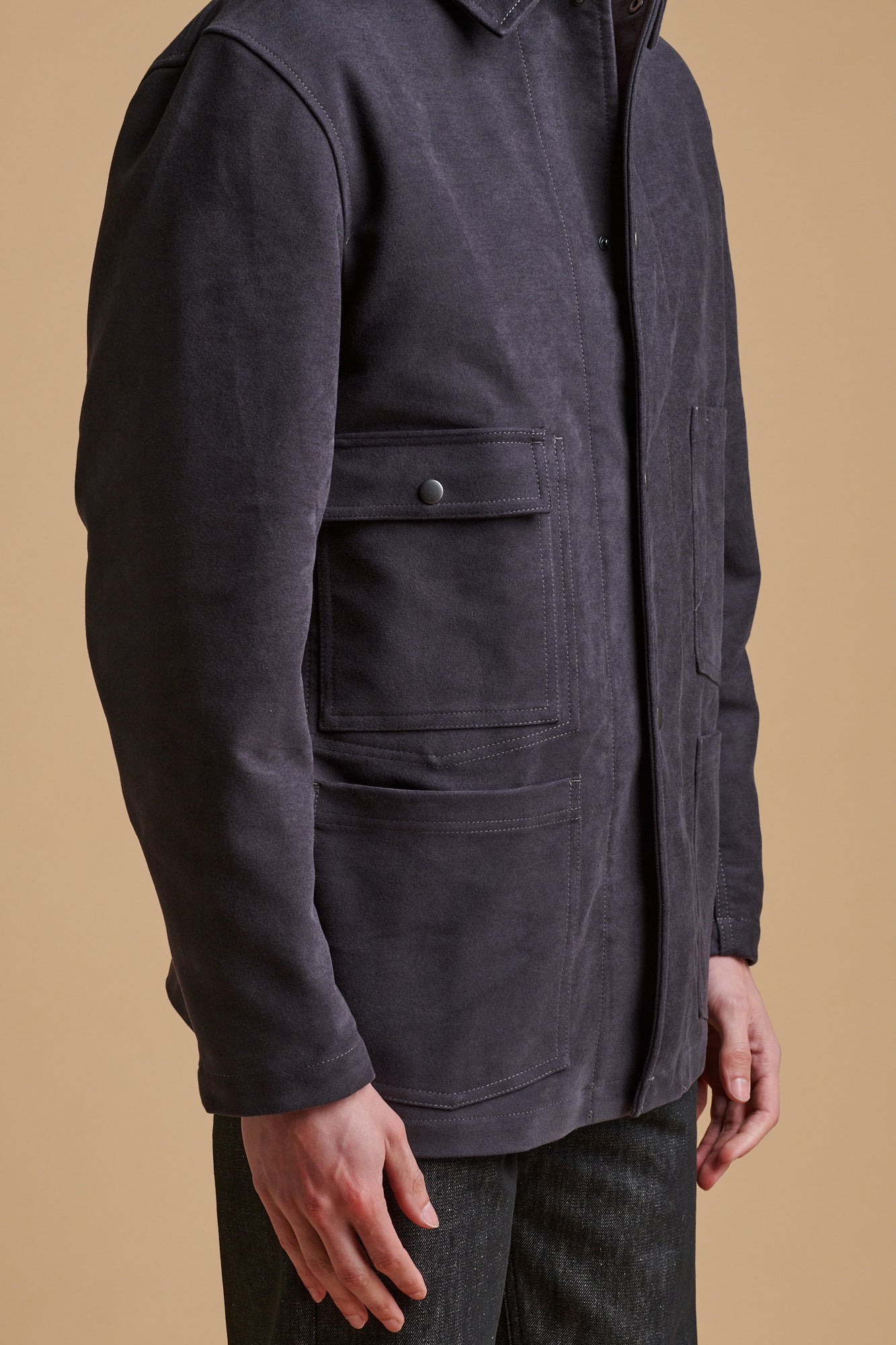 details of the front pockets on men's wearing Carter moleskin chore jacket in slate.