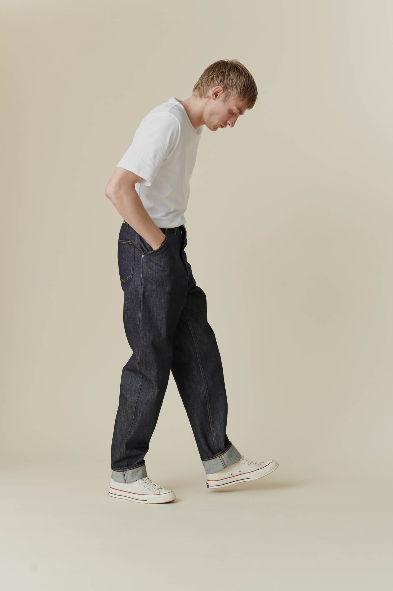 Full body side shot of male in chore jean indigo
