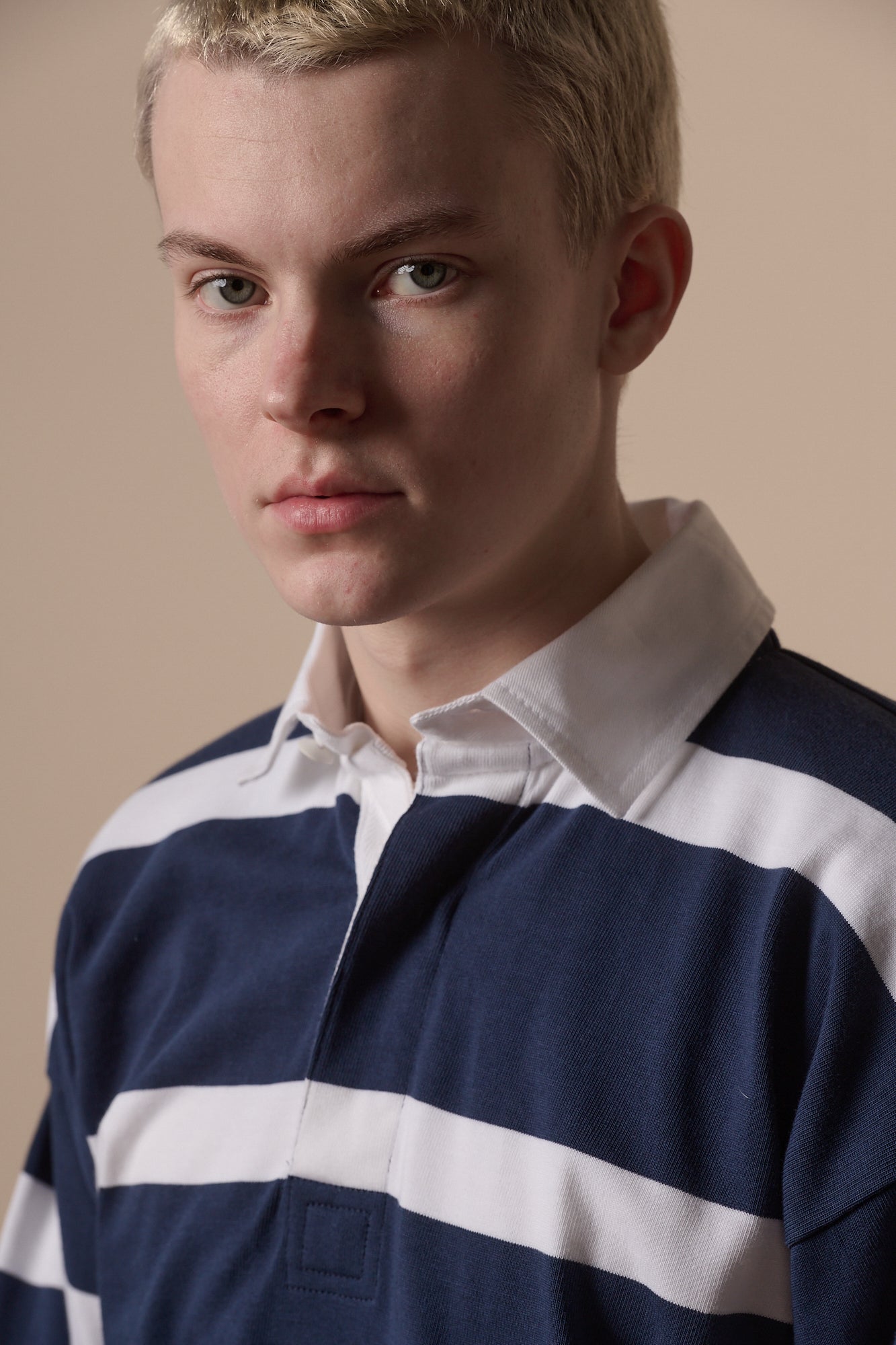 Portrait of white male wearing rugby shirt in navy white 
