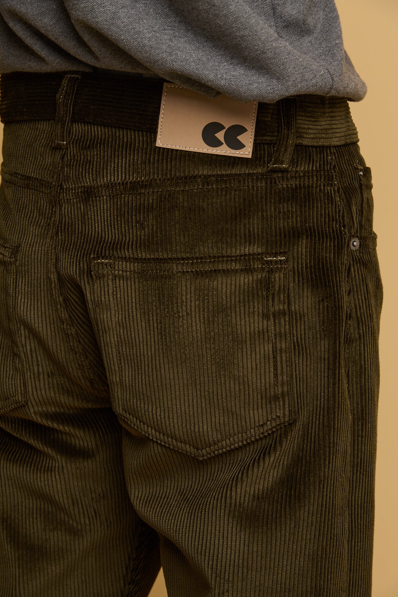 Close up of the back of Community Clothing men's five pocket cord trousers in dark olive 
