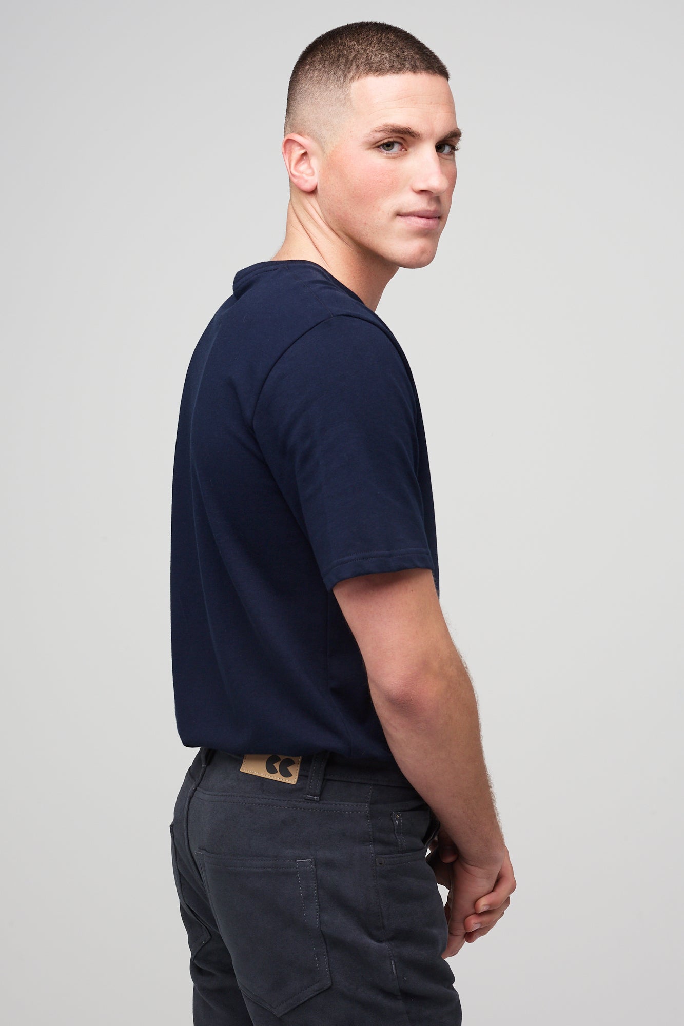 Brunette white male wearing navy Five Pocket Moleskin Jeans styled with navy short sleeve t-shirt and black shoes 