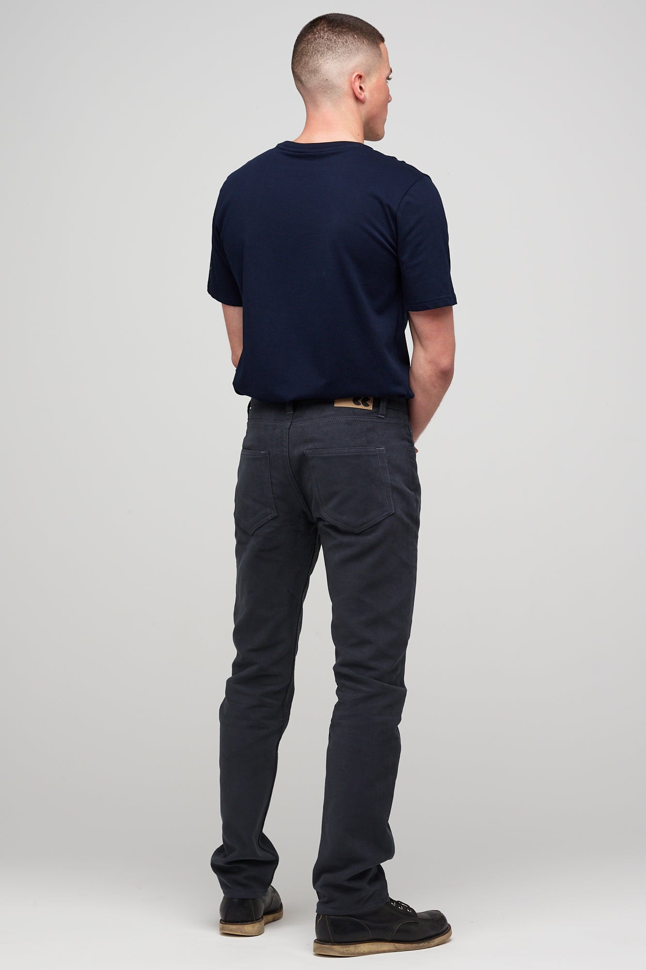 Brunette white male wearing navy Five Pocket Moleskin Jeans styled with navy short sleeve t-shirt and black shoes 