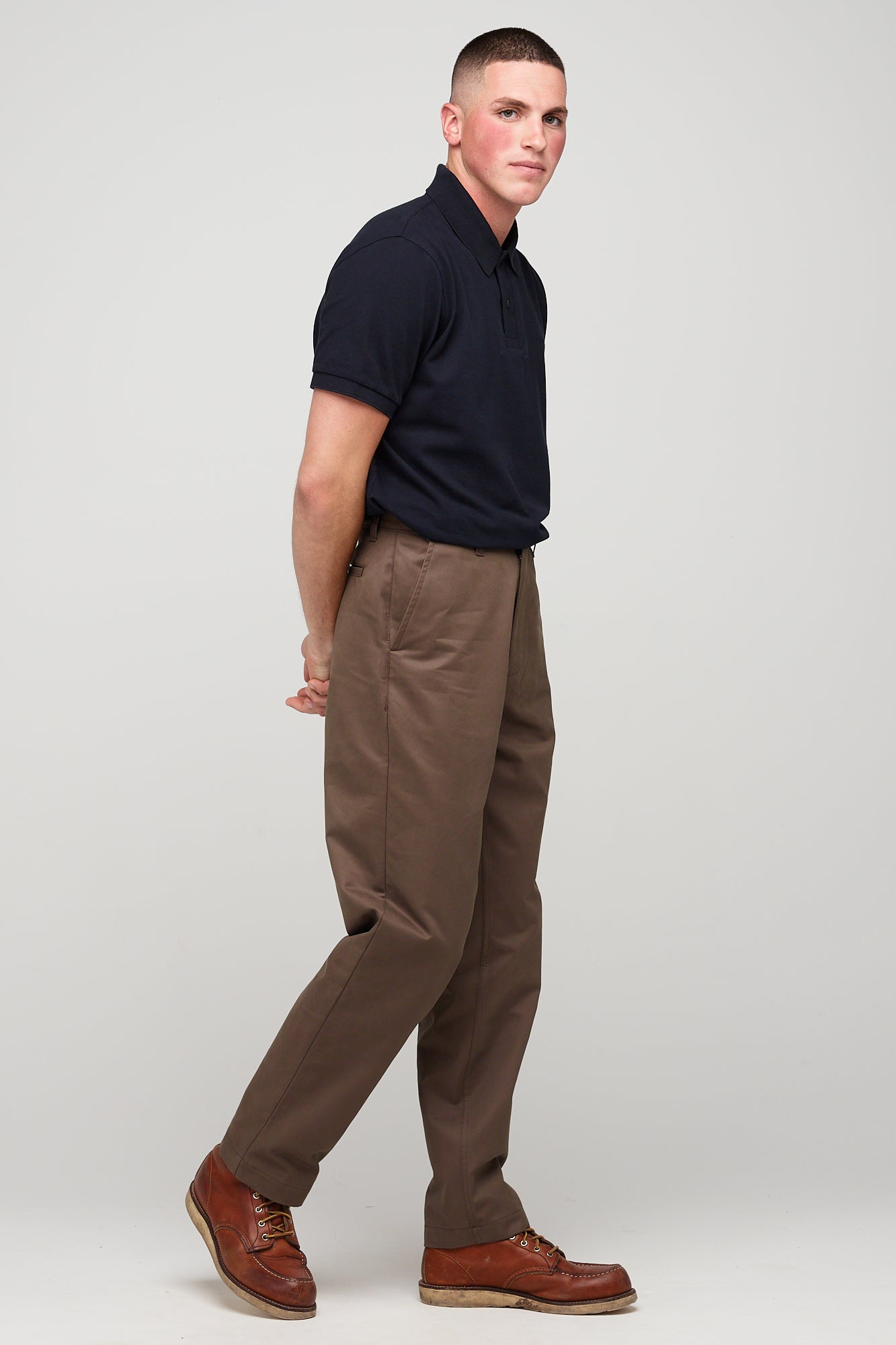 white brunette male in heavyweight relaxed chino brown styled with short sleeve polo shirt