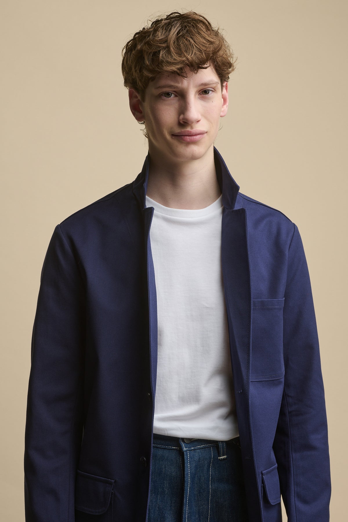 male wearing Men's James Single Breasted Blazer in Navy with collar up, worn over white t shirt