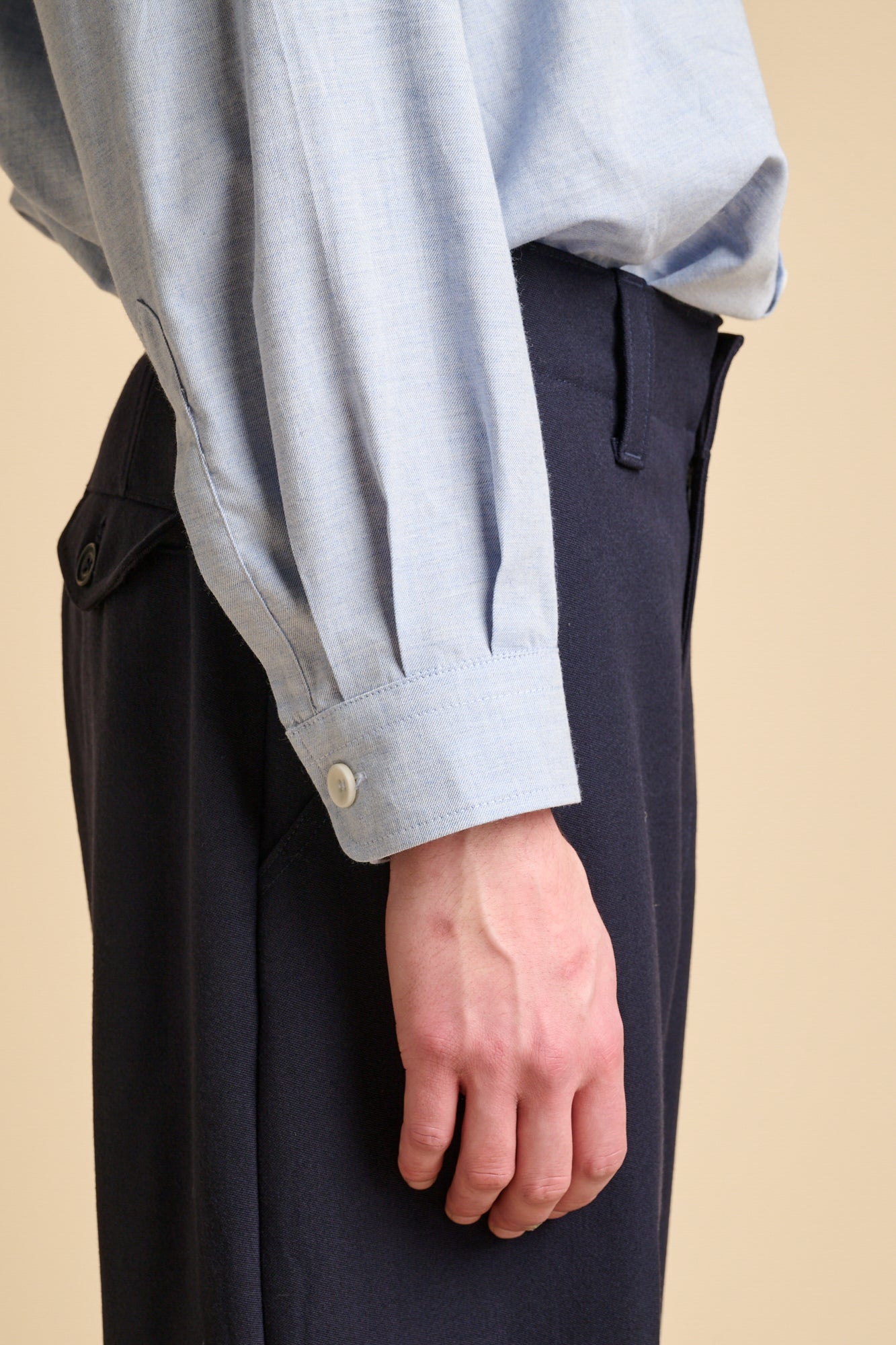 A close up of the cuff details of light blue shirt.