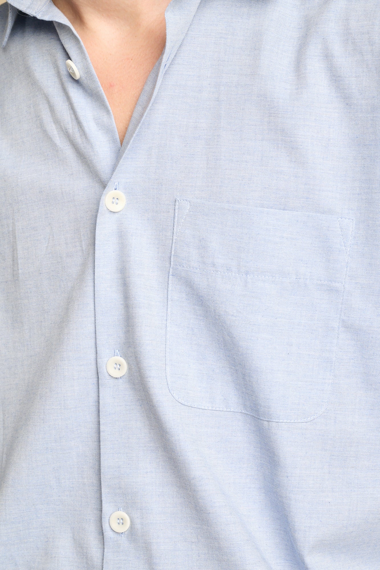 Close up of light blue marl shirt with chest pocket.
