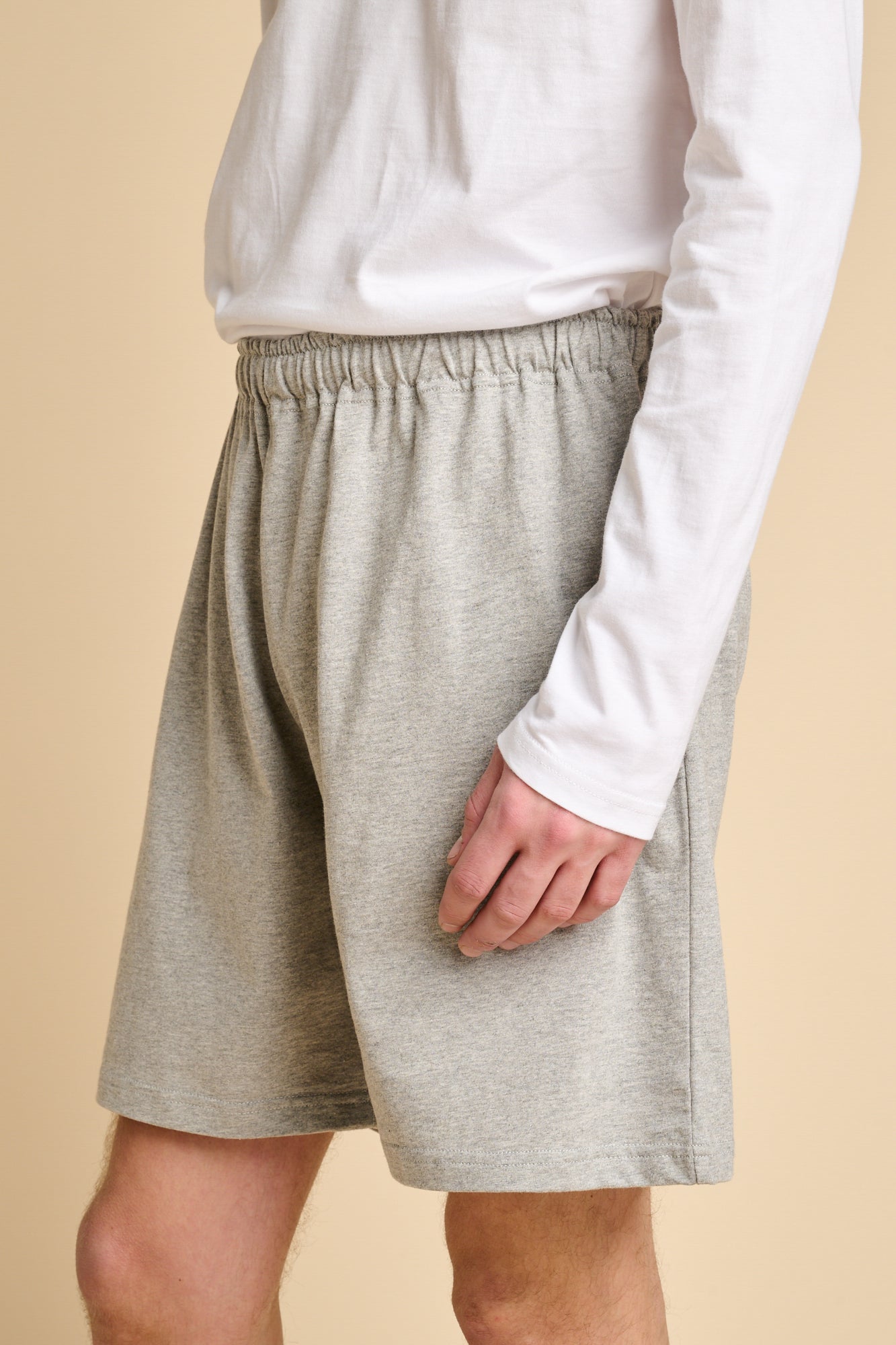 Man wearing grey marl jersey shorts.