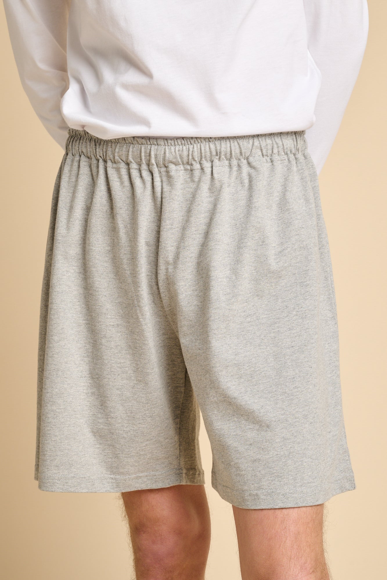 Man wearing grey marl jersey shorts.
