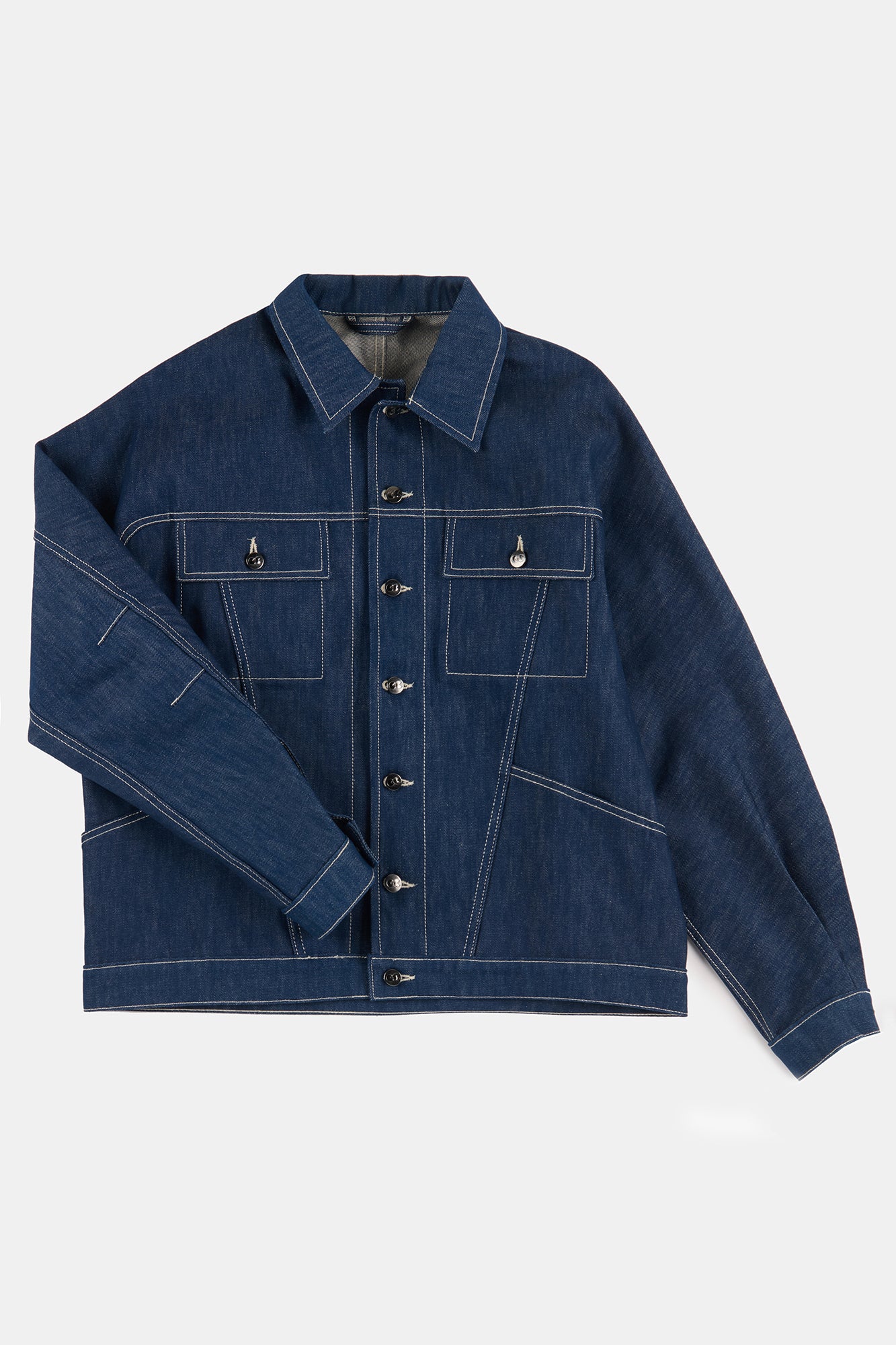Flatlay product shot of men's Joe denim jacket in blue denim with contrast white stitching 
