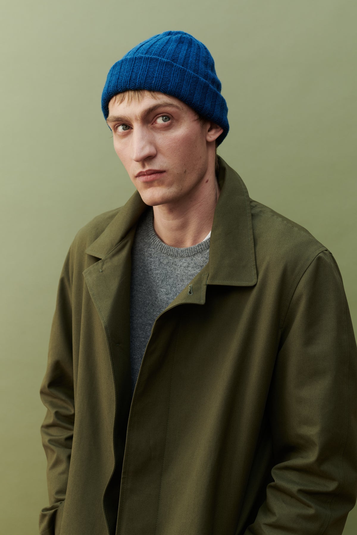 Male wearing unisex lambswool beanie hat in bright blue