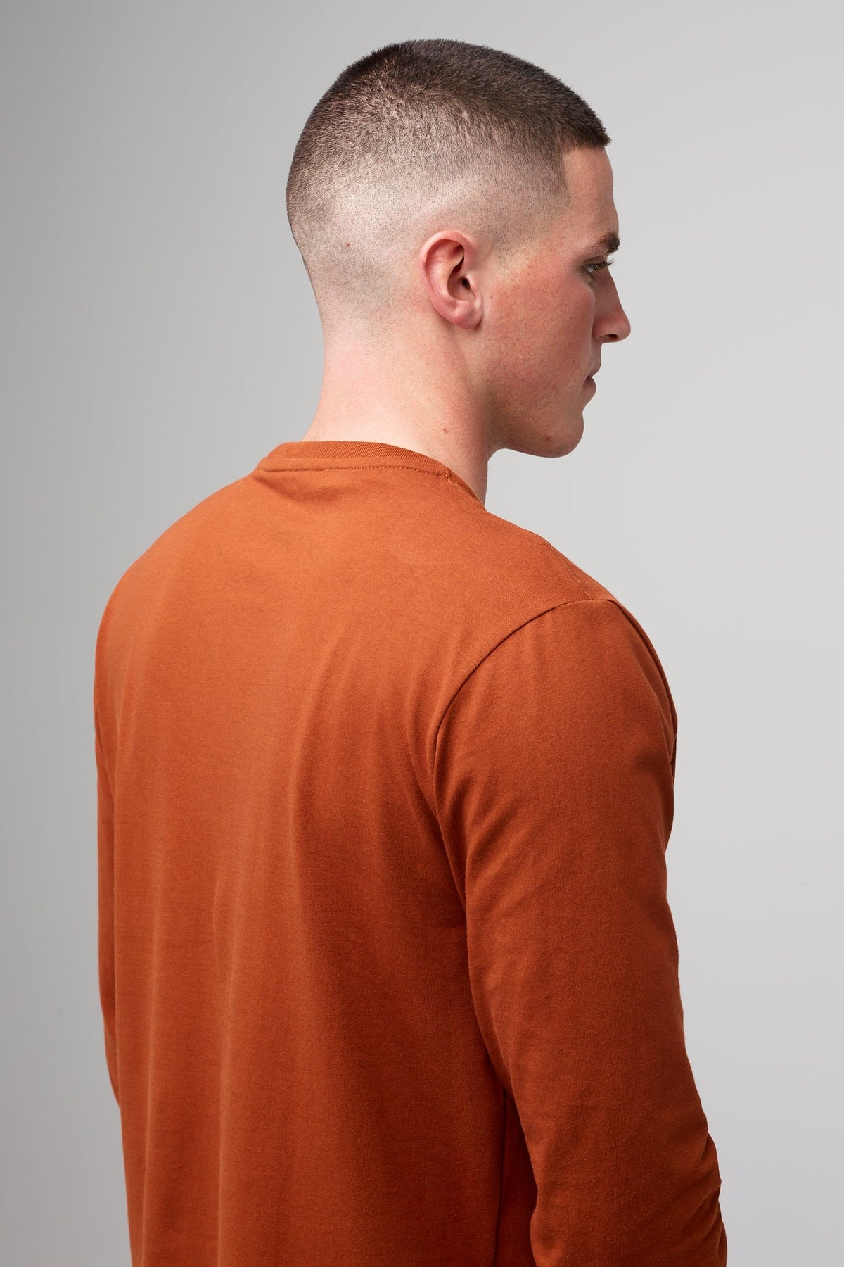 Brunete, white male wearing long sleeve t-shirt in cinnamon 