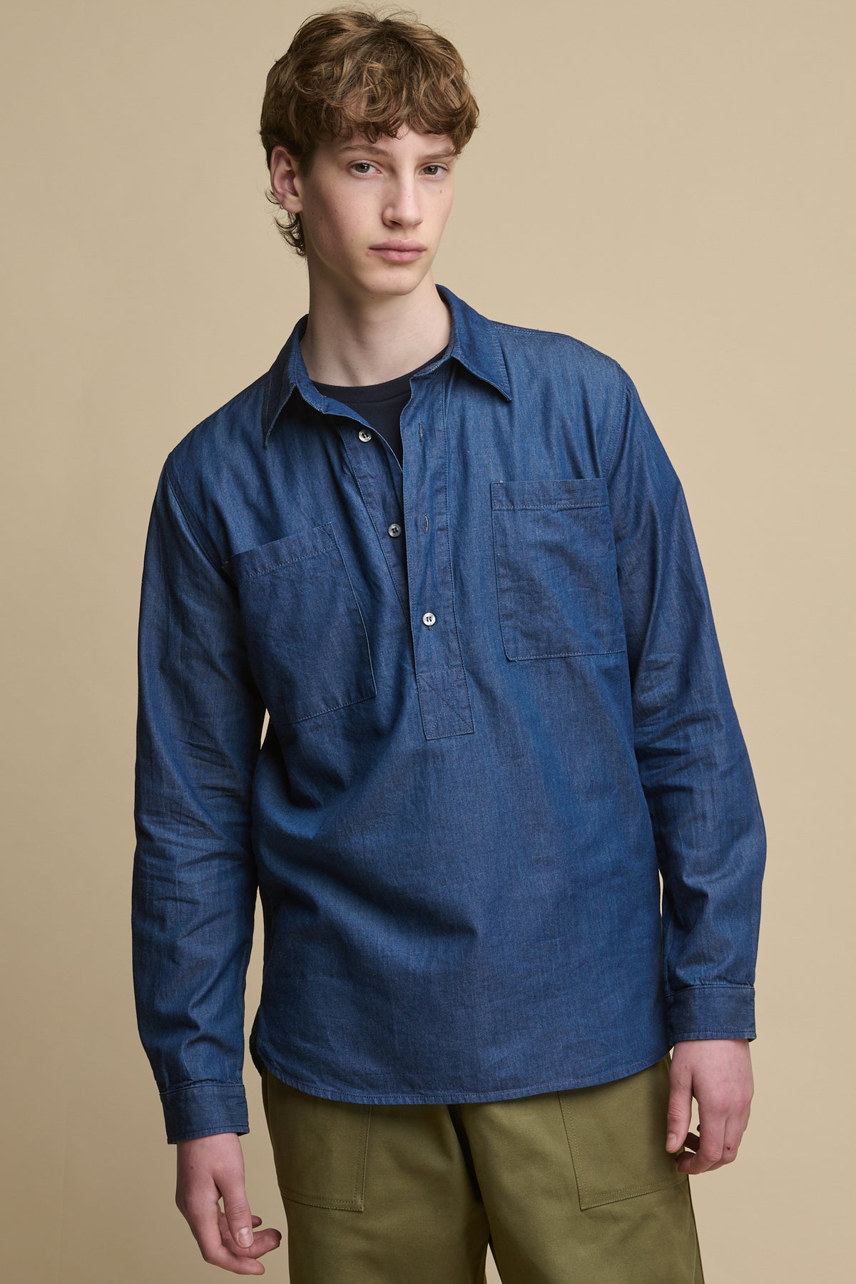 Thigh up image of male wearing Oli Half Placket Lightweight Denim Shirt in Indigo 