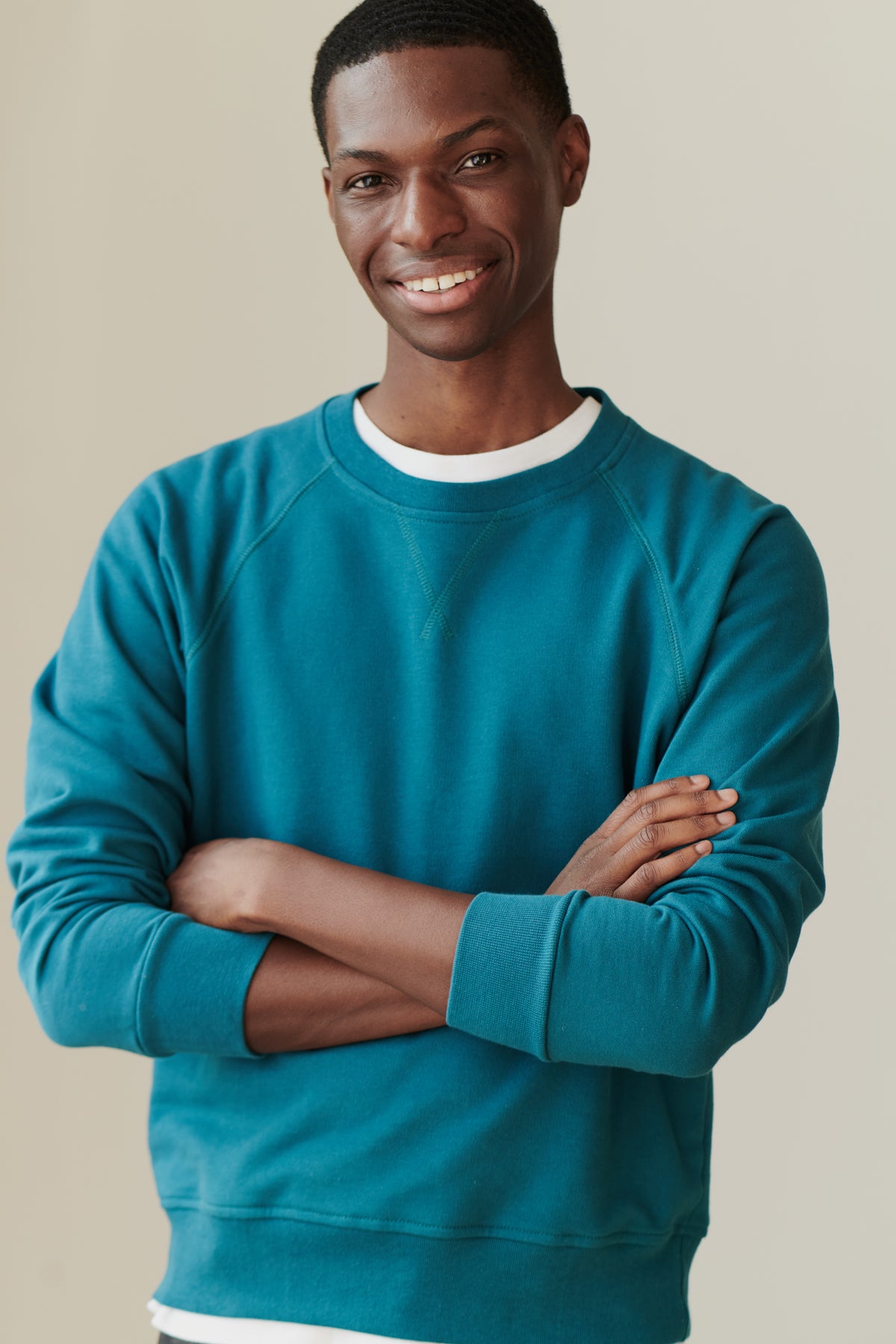 Front of male in men's raglan sweatshirt in teal