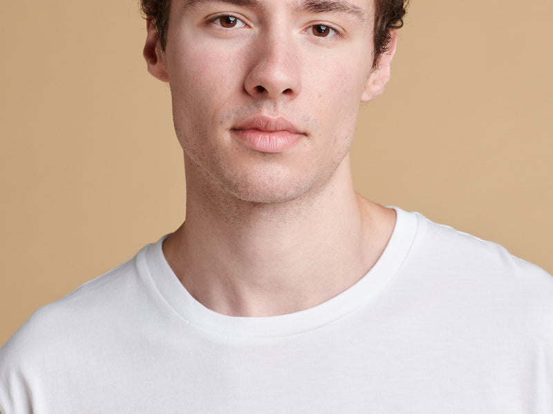 Portrait of male wearing short sleeve graphic t shirt with Metro car print.