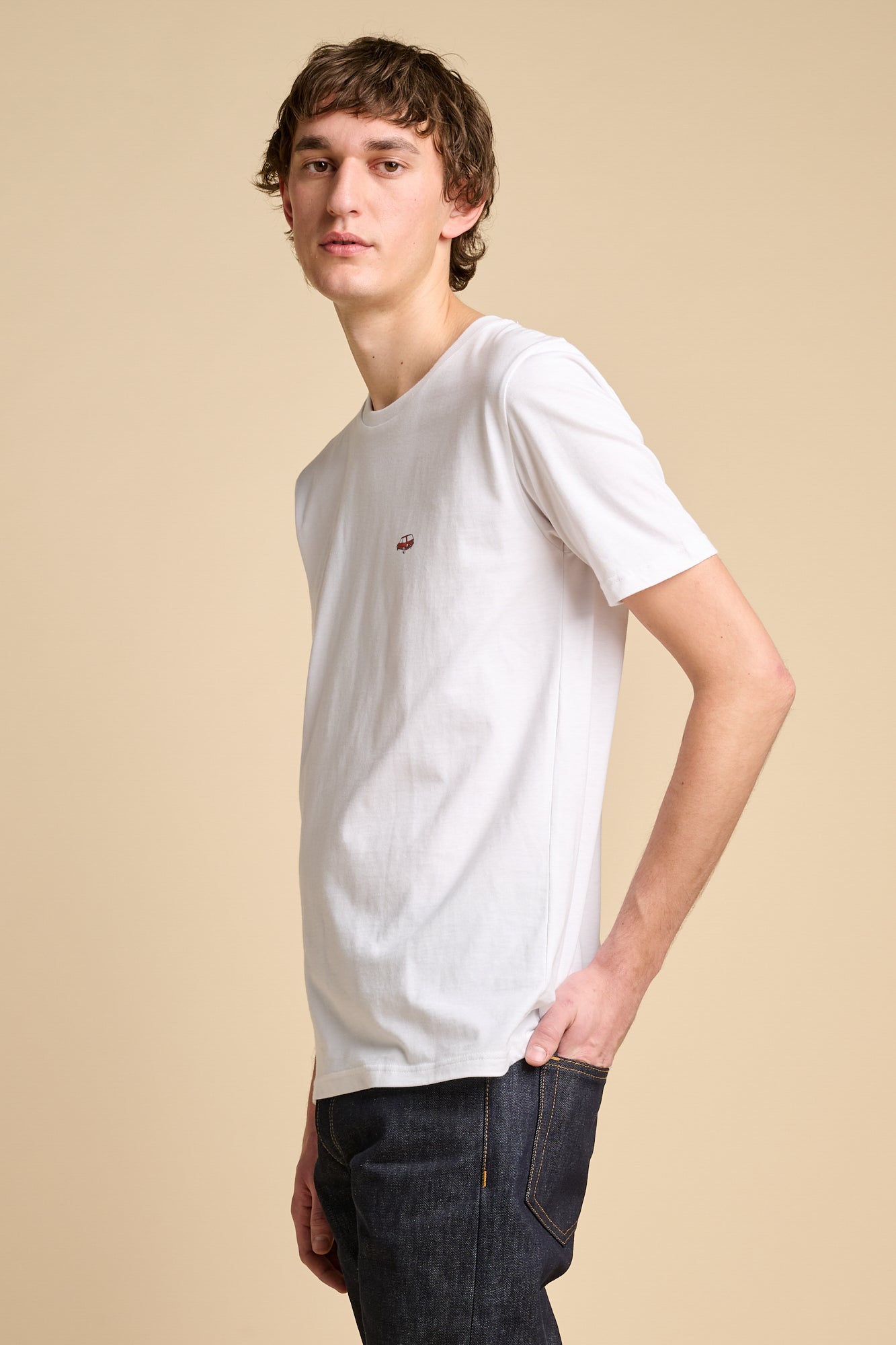 Smiling man wearing short sleeve white t shirt with graphic.