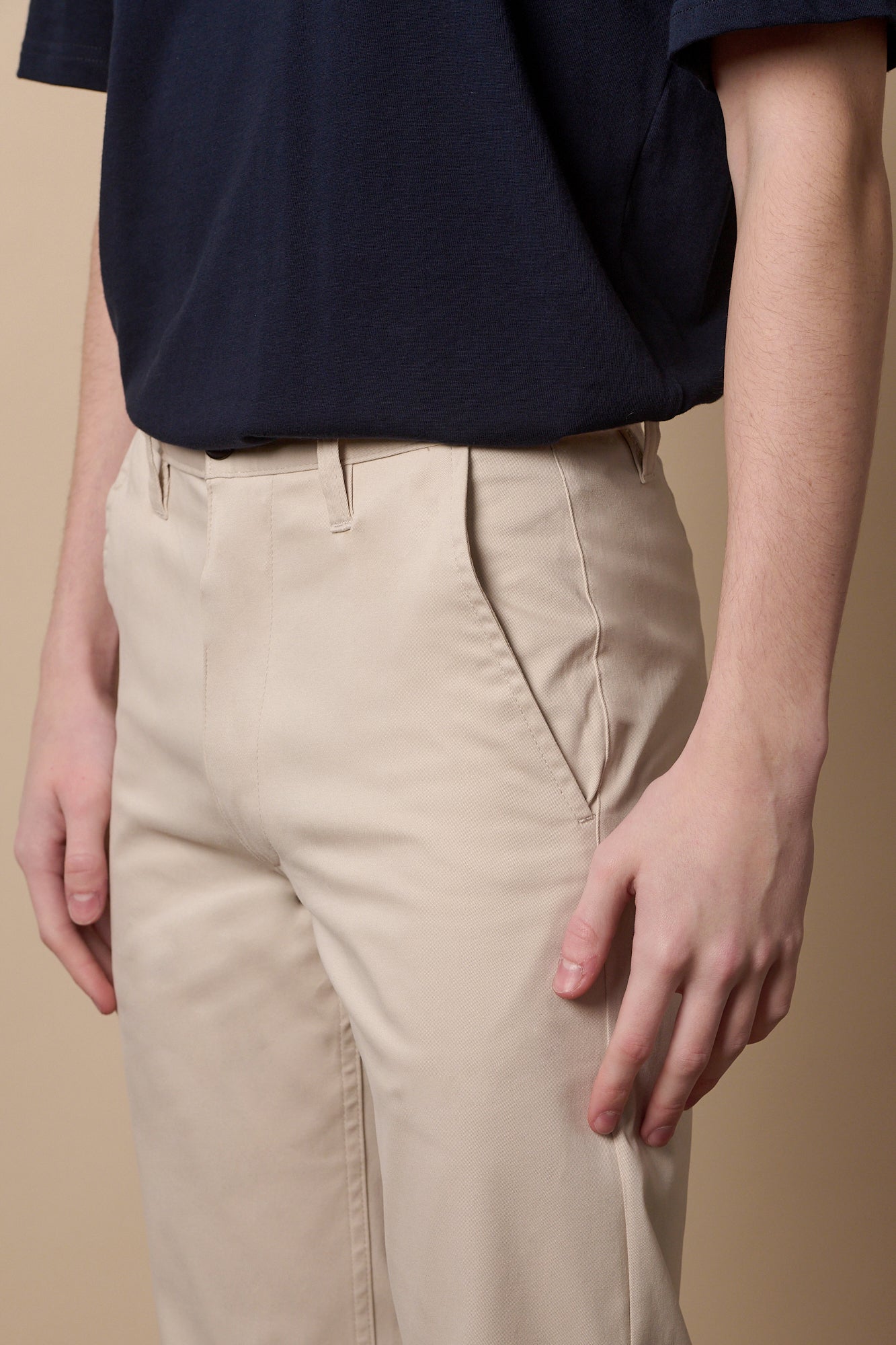 Full body image of male wearing slim stretch chino in light stone
