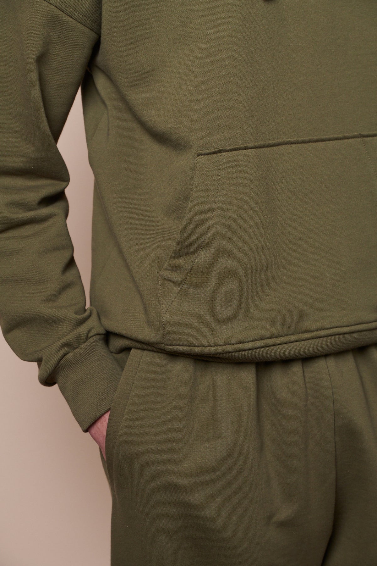 close up image of male with hand in front pocket on sweatpants