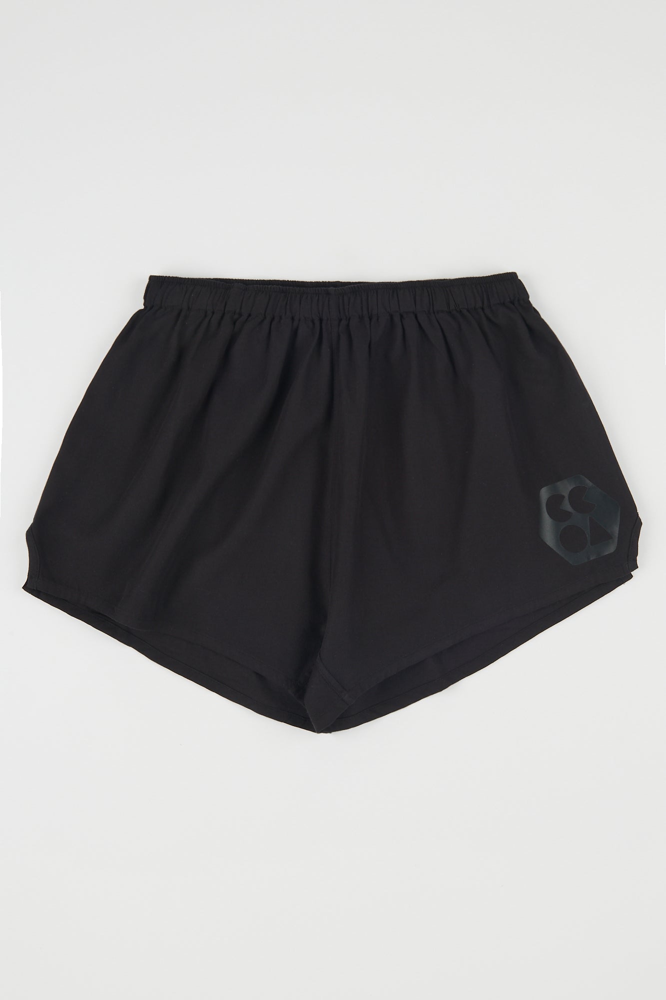 Flatlay product shot of men's lightweight sports short plastic free in black with CCOA logo