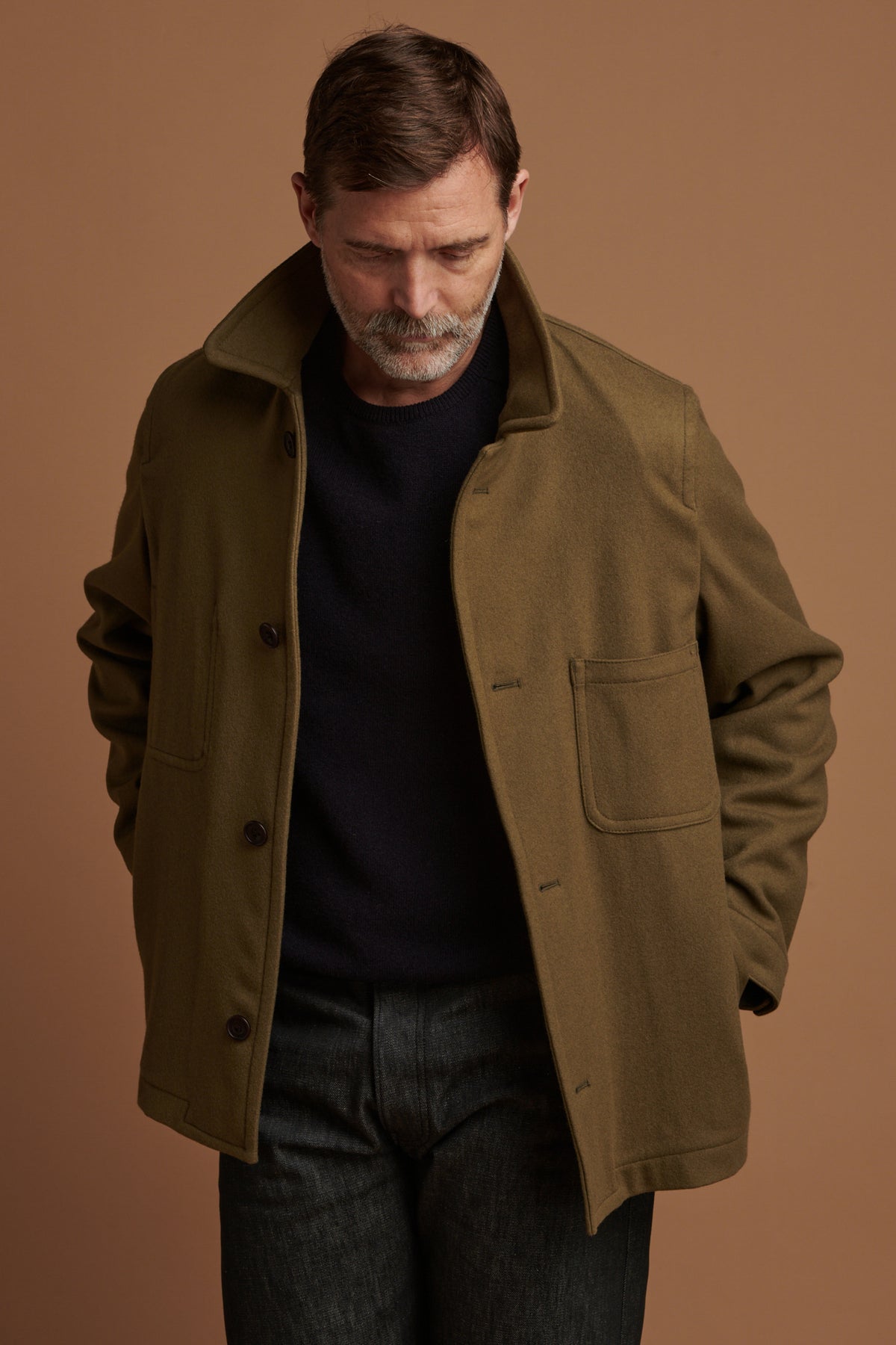 Patrick Grant wearing Community Clothing    Arthur wool chore jacket in olive with the collar up. Worn over lambswool saddle shoulder crew neck in navy.