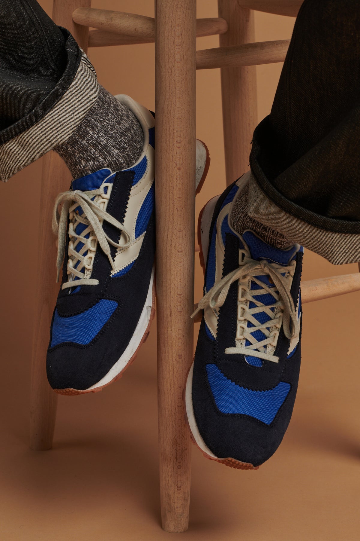 Close up of male wearing men's Parlick trainers in blue and navy 