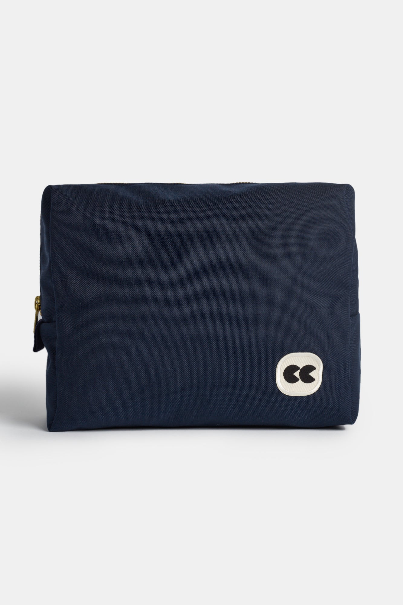 Image showing the front of medium sized pouch in navy. Small CC logo badge on the botton right corner