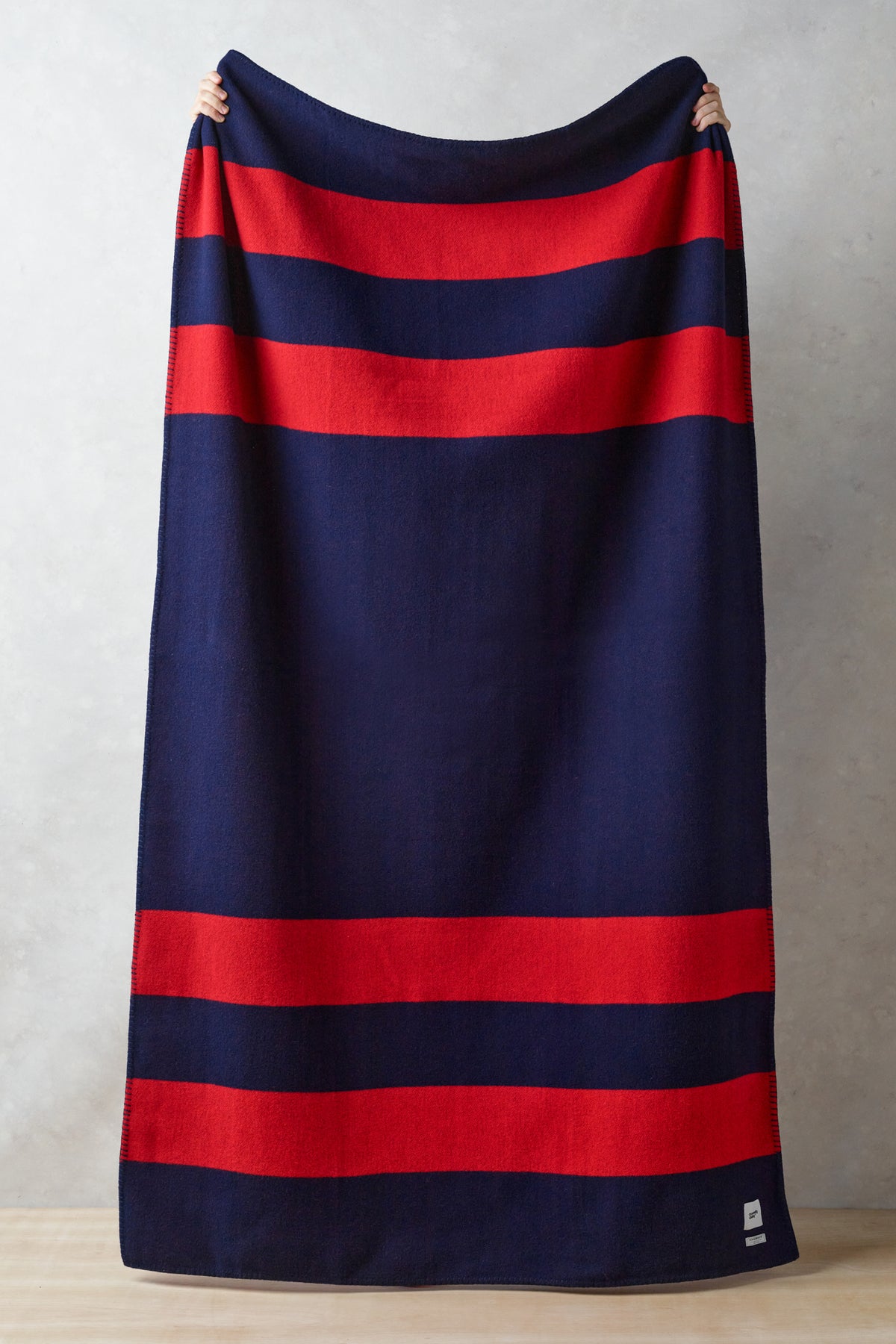 Image showing full length of navy and red striped pure merino wool blanket