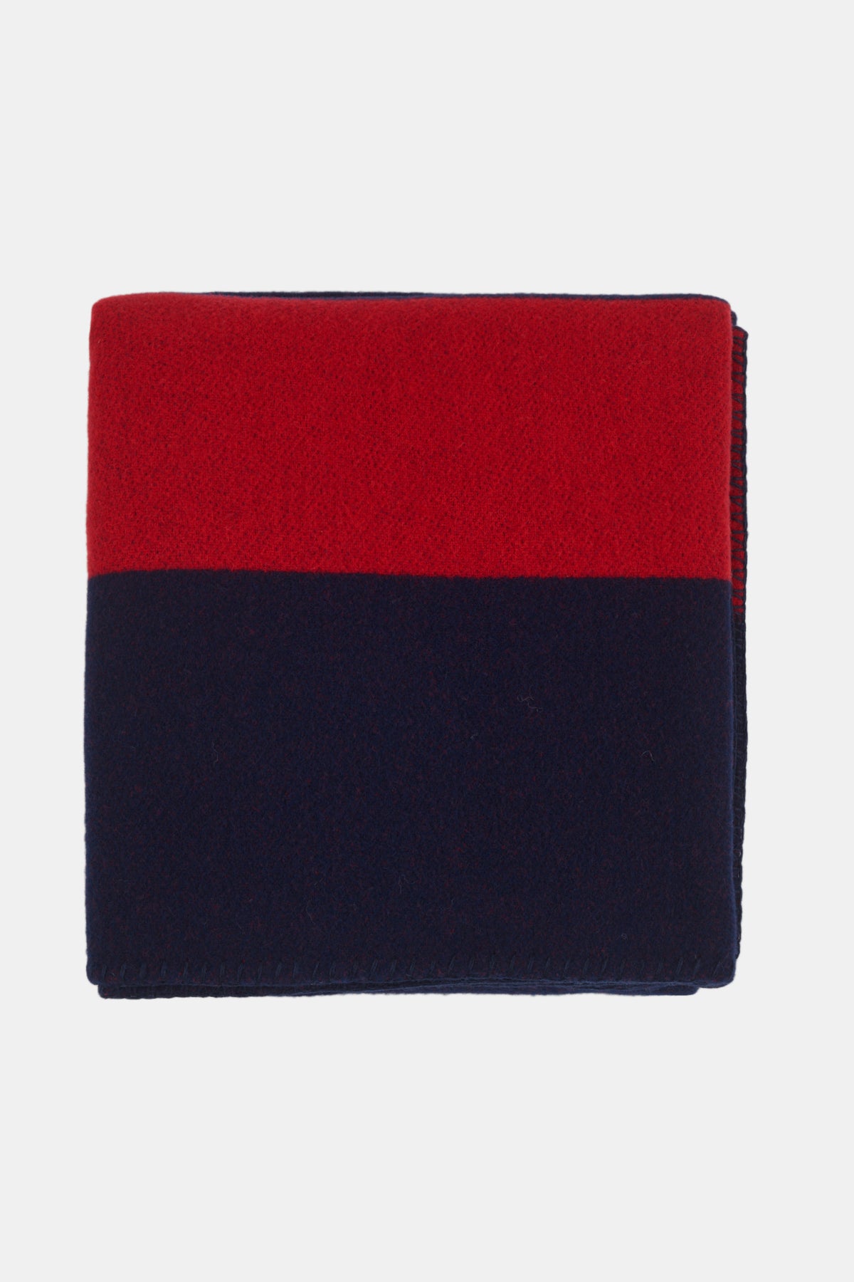 Flatlay image of folded pure wool blanket in navy red